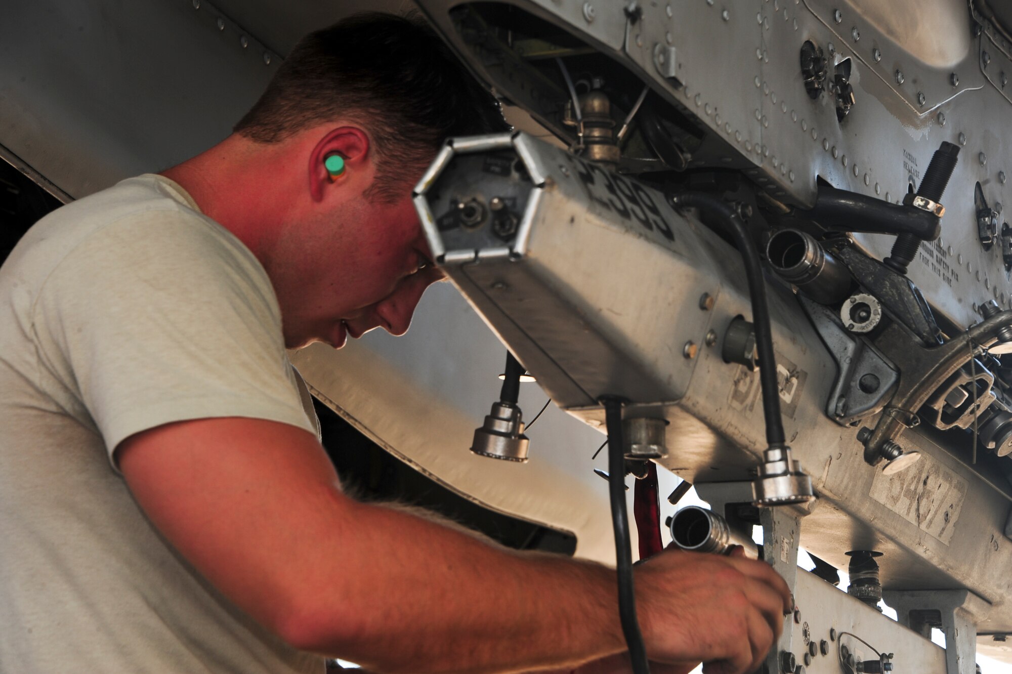 U.S. Air Force Airman 1st Class Christopher Sisk, 354th Aircraft Maintenance Unit load crew team member, preps a triple ejector rack during a load crew of the quarter contest at Davis-Monthan Air Force Base, Ariz., Oct. 2, 2015. Sisk was among the six Airmen that participated in the contest. (U.S. Air Force photo by Airman Nathan Barbour/Released)