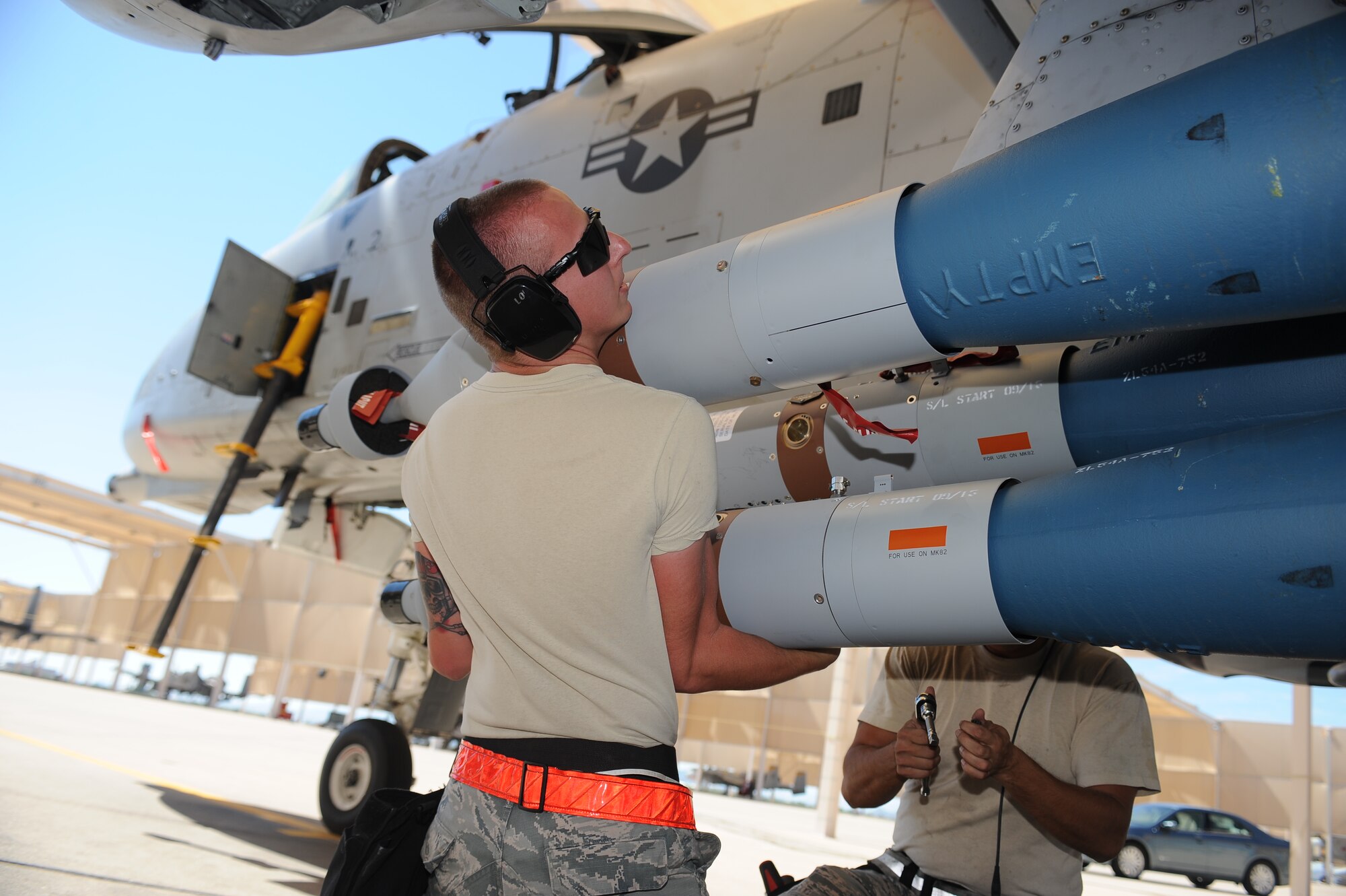 U.S. Air Force Senior Airman Riley McIrvin, 924th Aircraft Maintenance Squadron weapons crew member, loads a Guided Bomb Unit-12 Paveway II onto an A-10 Thunderbolt II during a load crew of the quarter contest at Davis-Monthan Air Force Base, Ariz., Oct. 2, 2015. During the contest, the load crews were evaluated on timeliness and deficiencies. (U.S. Air Force photo by Airman 1st Class Ashley Steffen/Released)