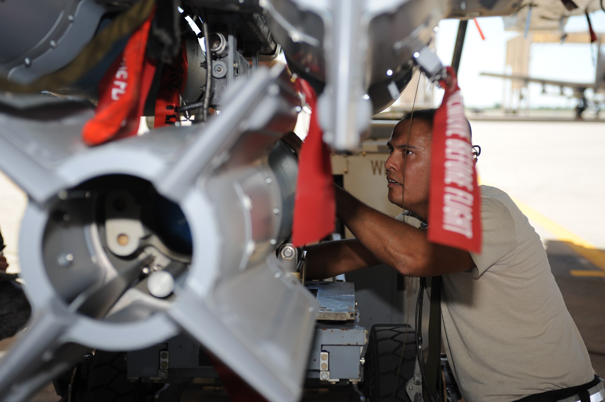 U.S. Air Force Staff Sgt. Steve Carvalho, 924th Aircraft Maintenance Squadron weapons team chief, loads a Guided Bomb Unit-12 Paveway II onto an A-10 Thunderbolt II during a load crew of the quarter contest at Davis-Monthan Air Force Base, Oct. 2, 2015. The objective of the contest is to determine which team can load an A-10 with munitions the fastest with the least deficiencies. (U.S. Air Force photo by Airman 1st Class Ashley Steffen/Released)