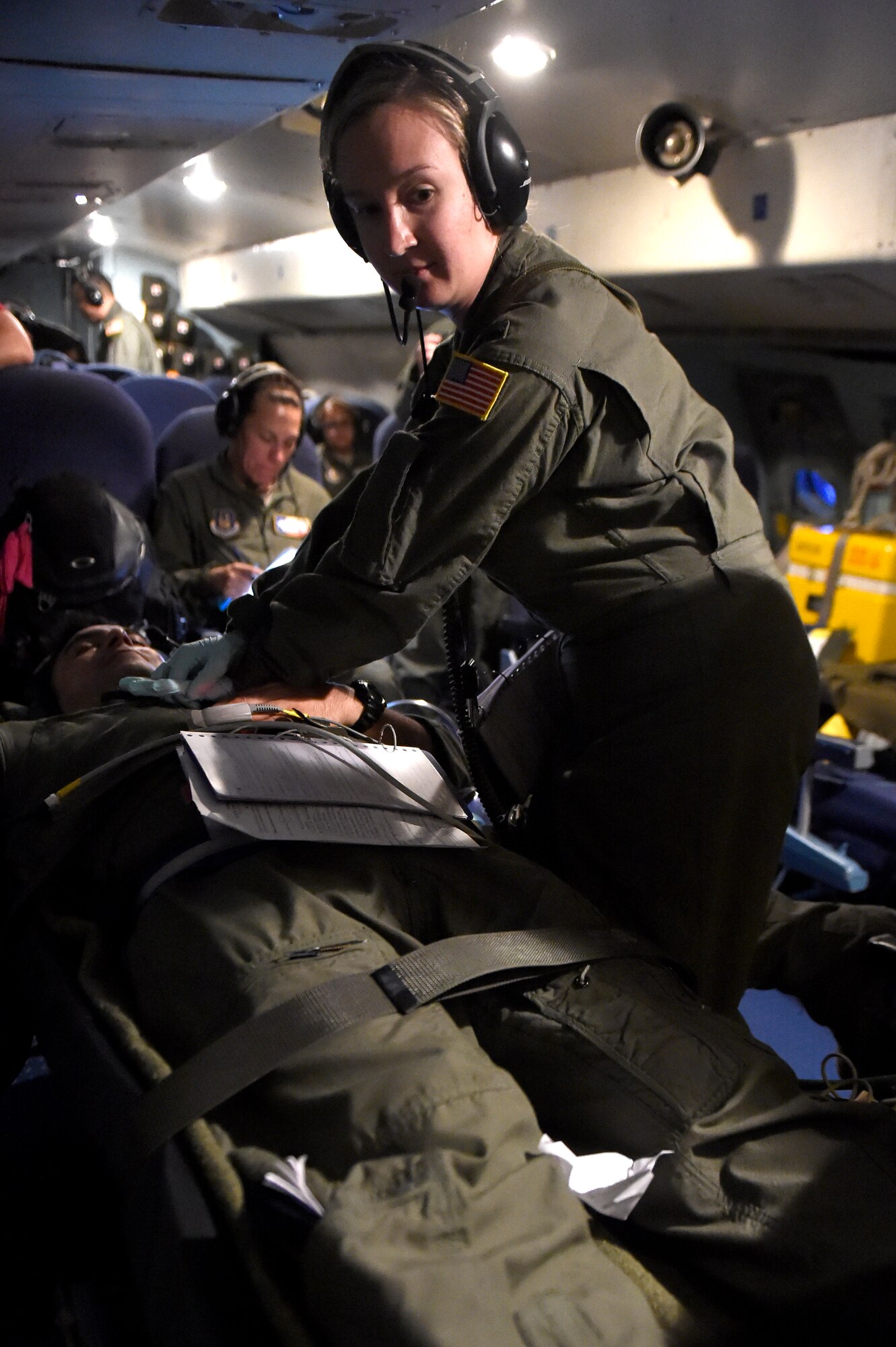 1st Lt. Stefanie Callen, 433rd Aeromedical Evacuation Squadron flight nurse, performs compressions on a patient during a training scenario aboard a C-5 Galaxy aircraft Oct. 7, 2015 at Joint Base San Antonio-Lackland, Texas. Configuring a C-5 to meet their needs, the 433rd AES members established and met requirements to conduct Aeromedical Readiness Missions while maintaining the focus on the patient, significantly improving the efficiency and effectiveness of safe and responsive patients globally. (U.S. Air Force photo by Senior Airman Keith James/Released)