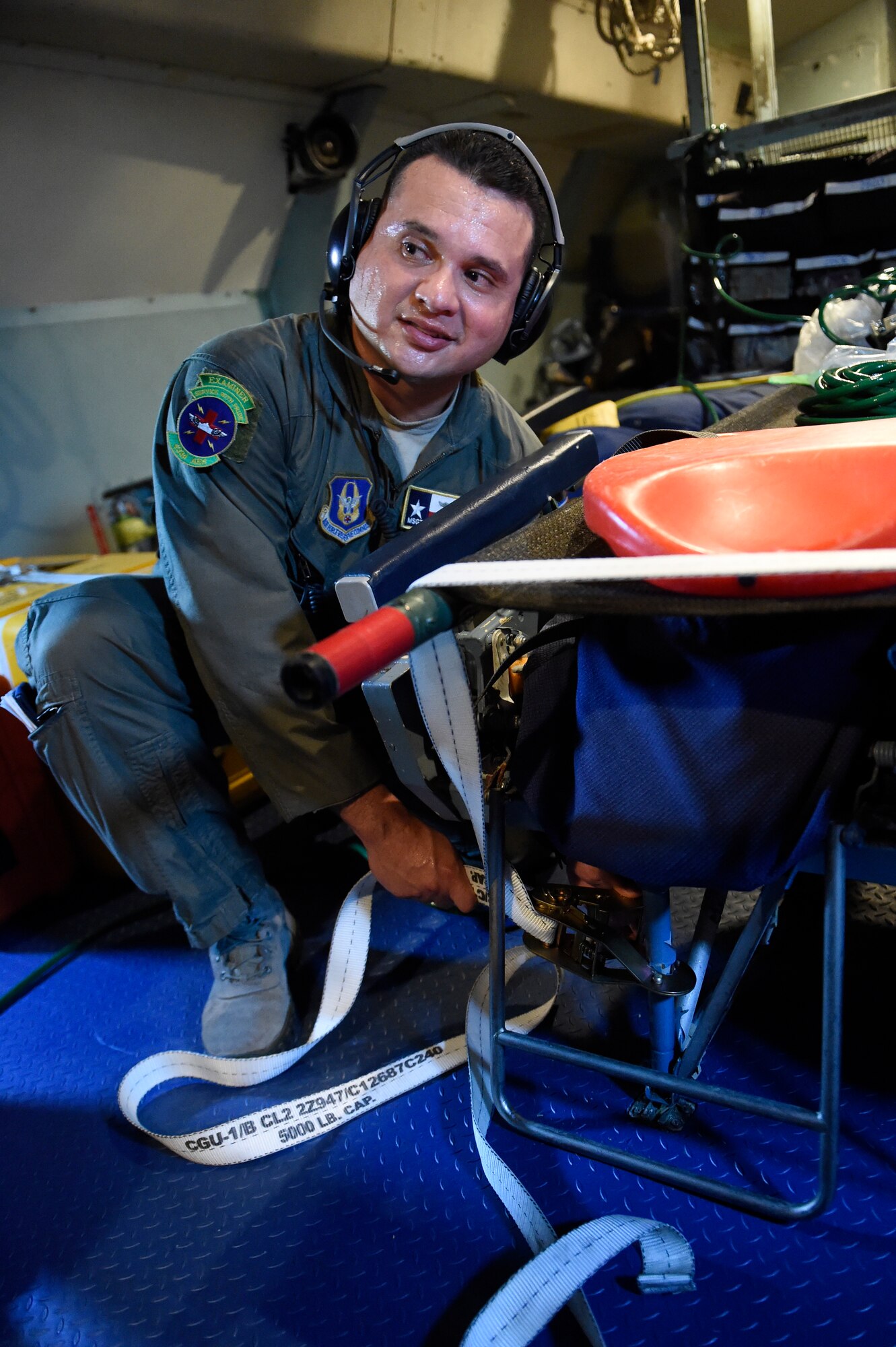 Master Sgt. Jerry Gonzales, 433rd Aeromedical Evacuation Squadron medical technician, fastens a litter for a medical scenario on-board a C-5A Galaxy Oct. 7, 2015 at Joint Base San Antonio-Lackland, Texas. Configuring a C-5 to meet their needs, the 433rd AES members established and met requirements to conduct air reserve missions while maintaining the focus on the patient, significantly improving the efficiency and effectiveness of safe and responsive patients globally. (U.S. Air Force photo by Senior Airman Keith James/Released)