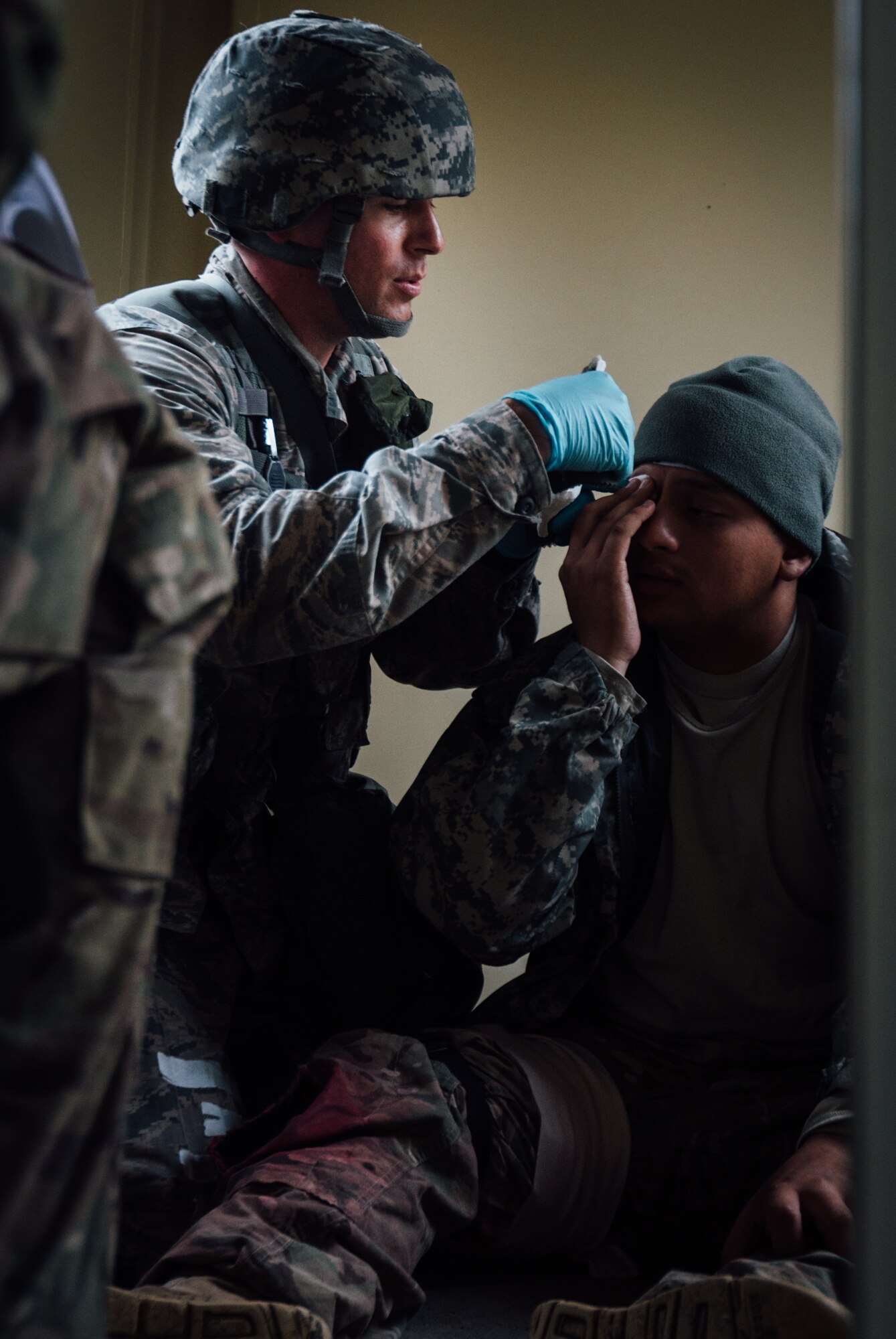 Capt. Ryan Garabrandt, 446th Aeromedical Staging Squadron Expert Field Medic Badge candidate, provides medical care to an injured simulated patient during the EFMBvcourse while a cadre grades him at Joint Base Lewis-McChord, Wash., Sept. 25, 2015. In June 1965, the U.S. Army expanded its awards program by implementing the EFMB for combat medics who do not see battle. (U.S. Air Force photo by Senior Airman Jordan Castelan/Released)
