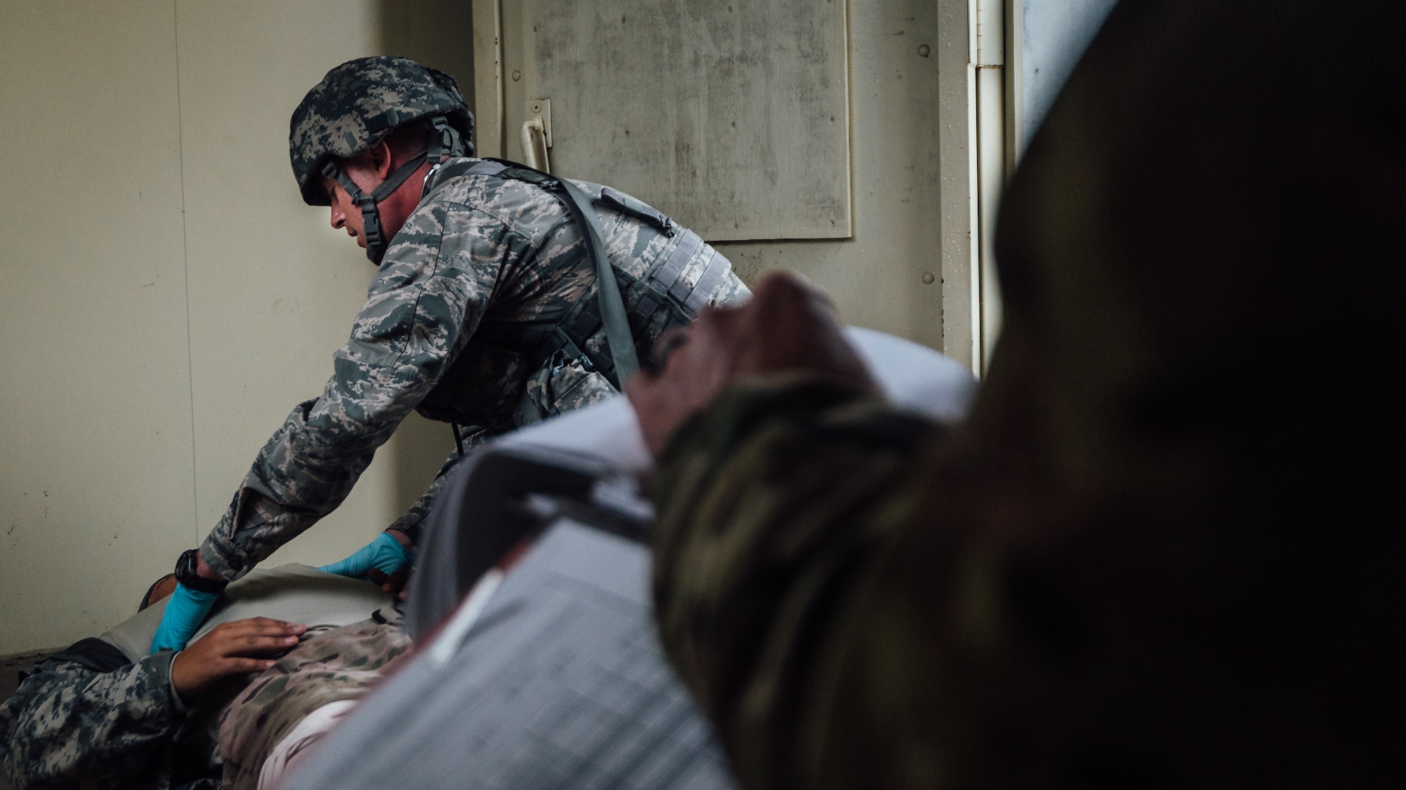 Capt. Ryan Garabrandt, 446th Aeromedical Staging Squadron Expert Field Medic Badge candidate, provides medical care to an injured simulated patient during the Expert Field Medic Badge course while a cadre grades him at Joint Base Lewis-McChord, Wash., Sept. 25, 2015. The EFMB is the non-combat equivalent of the Combat Medical Badge and is awarded to medical personnel of the U.S. military who successfully complete a set of qualification tests. (U.S. Air Force photo by Senior Airman Jordan Castelan/Released)