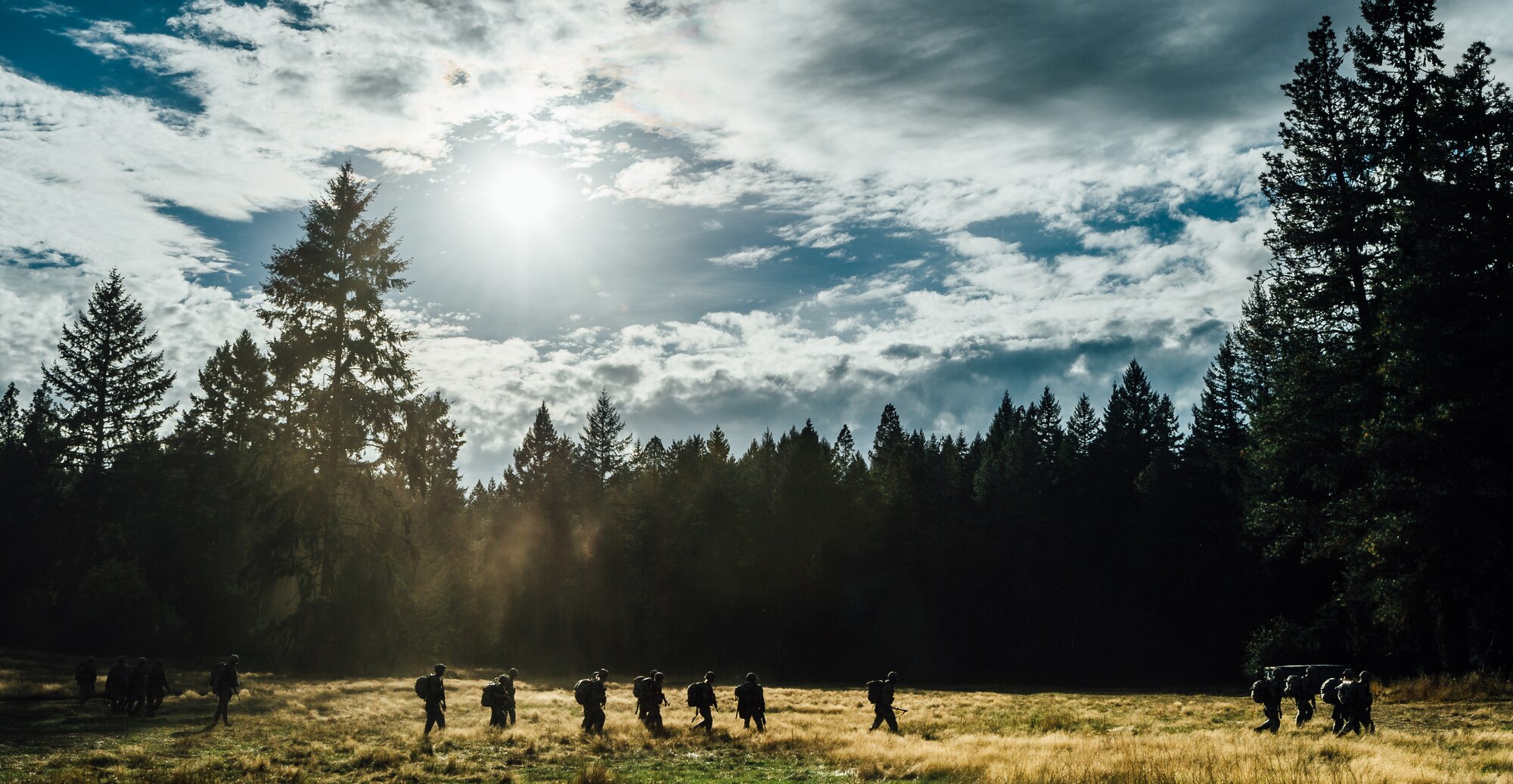 A group of soldiers walk back to the central campground during the Expert Field Medic Badge course at Joint Base Lewis-McChord, Wash., Sept. 24, 2015. In June 1965, the U.S. Army expanded its awards program by implementing the EFMB for combat medics who do not see battle. (U.S. Air Force photo by Senior Airman Jordan Castelan/Released)