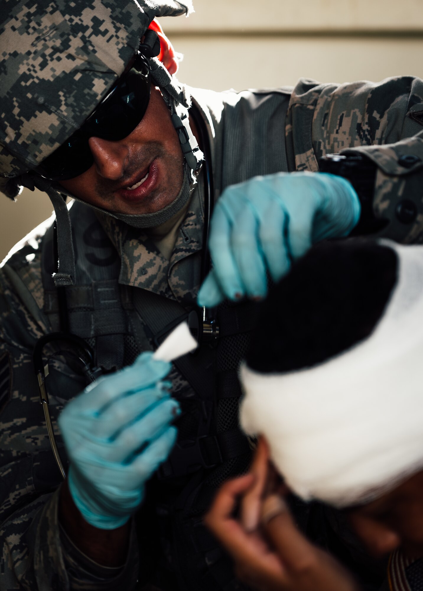 Staff Sgt. Remeet Singh, 446th Aeromedical Staging Squadron Expert Field Medic Badge candidate, provides medical care to a simulated patient during the EFMB course at Joint Base Lewis-McChord, Wash., Sept. 24, 2015. In June 1965, the U.S. Army expanded its awards program by implementing the EFMB for combat medics who do not see battle. (U.S. Air Force photo by Senior Airman Jordan Castelan/Released)