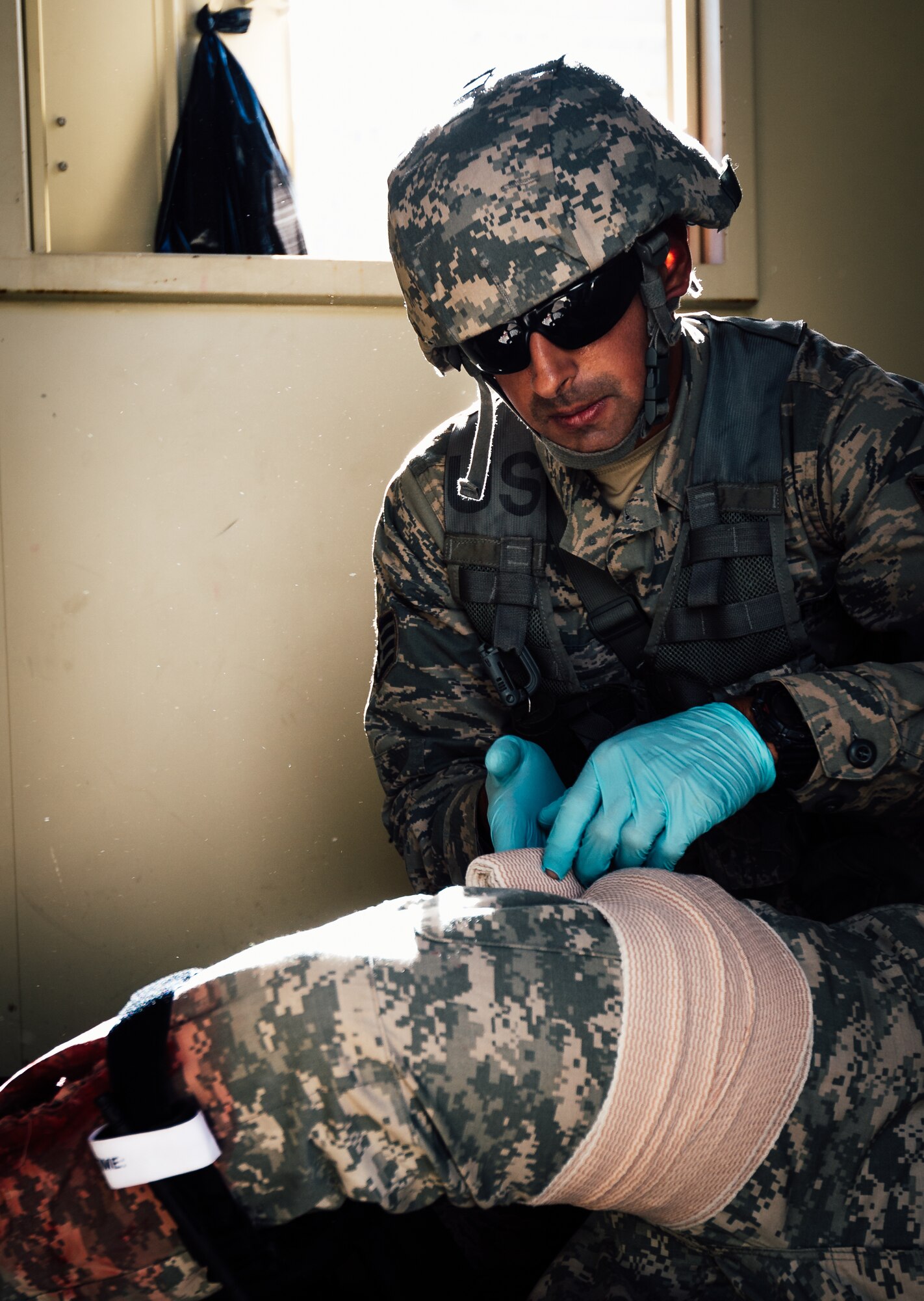 Staff Sgt. Remeet Singh, 446th Aeromedical Staging Squadron Expert Field Medic Badge candidate, provides medical care to a simulated patient during the EFMB course at Joint Base Lewis-McChord, Wash., Sept. 24, 2015. The EFMB is the non-combat equivalent of the Combat Medical Badge and is awarded to medical personnel of the U.S. military who successfully complete a set of qualification tests. (U.S. Air Force photo by Senior Airman Jordan Castelan/Released)