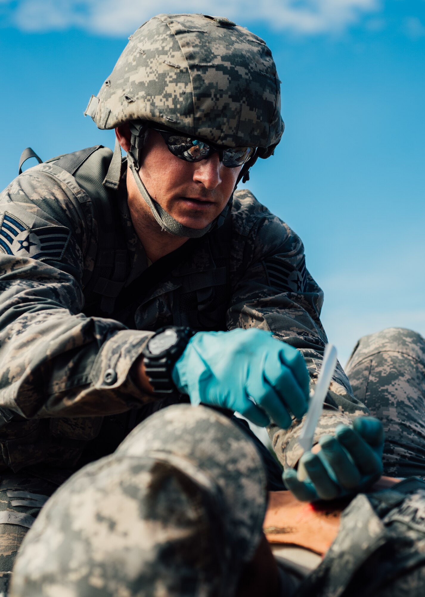 Staff Sgt. Kyle Bosshart, 446th Aeromedical Staging Squadron Expert Field Medic Badge candidate, provides medical care to a simulated patient during the EFMB course at Joint Base Lewis-McChord, Wash., Sept. 24, 2015. In June 1965, the U.S. Army expanded its awards program by implementing the EFMB for combat medics who do not see battle. (U.S. Air Force photo by Senior Airman Jordan Castelan/Released)