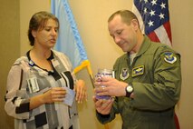 Christle Usera, 28th Medical Group Family Advocacy intervention specialist, left, explains the Domestic Violence Awareness Month ?Light in the Window? campaign to Col. Gentry Boswell, 28th Bomb Wing commander, right, at Ellsworth Air Force Base, S.D., Oct. 1, 2015. Candles will be lit throughout the month of October to shed light on the devastating effects of domestic violence. (U.S. Air Force photo by Airman 1st Class Denise M. Nevins/Released) 