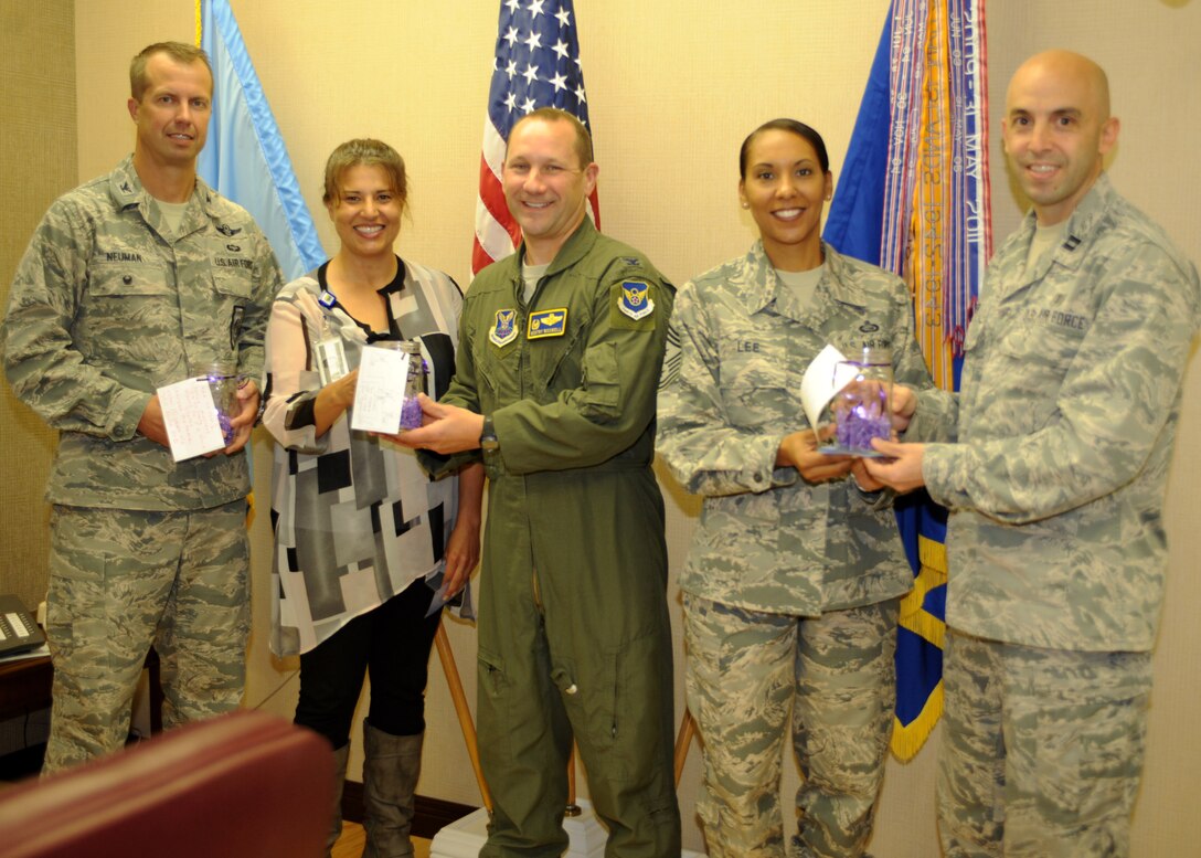 The Family Advocacy office presents Ellsworth leadership with candles as part of Domestic Violence Awareness Month at Ellsworth Air Force Base, S.D., Oct. 1, 2015. The candles, which will remain lit throughout the month of October, are part of the ?Light in the Window? campaign and signify community solidarity toward ending domestic violence. (U.S. Air Force photo by Airman 1st Class Denise M. Nevins/Released)