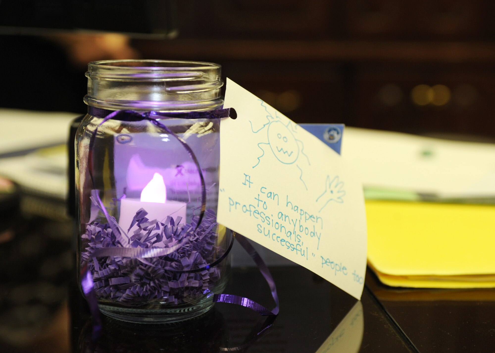 The Family Advocacy office presents candles to base leadership, to include first sergeants and squadron commanders, as part of the ?Light in the Window? campaign for Domestic Violence Awareness Month at Ellsworth Air Force Base, S.D., Oct. 1, 2015. The purpose of the candles is to prompt discussion and increase awareness about domestic violence. (U.S. Air Force photo by Airman 1st Class Denise M. Nevins/Released)
