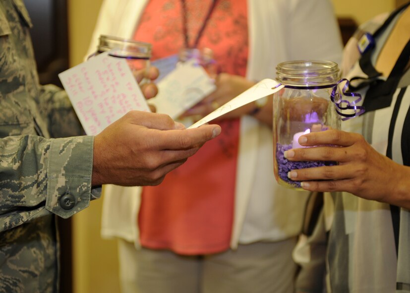 The Family Advocacy Program decorated candle jars in recognition of Domestic Violence Awareness Month at Ellsworth Air Force Base, S.D., Oct. 1, 2015. Notes were written by victims at the Working Against Violence, Inc. shelter in Rapid City, S.D., and attached to the candles in an effort to provide support and encouragement to other victims. (U.S. Air Force photo by Airman 1st Class Denise M. Nevins/Released)