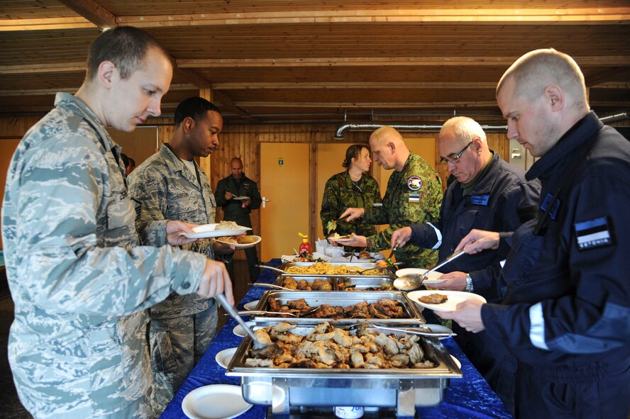 U.S. Air Force Airmen and Estonian air force Airmen go through the buffet line during an icebreaker event at Amari Air Base, Estonia, Oct. 1, 2015. The 74th Expeditionary Fighter Squadron Airmen, assigned to the 23d Wing at Moody Air Force Base, Georgia, are deployed as part of a Theater Security Package in support of Operation Atlantic Resolve. (U.S. Air Force photo by Andrea Jenkins/Released)