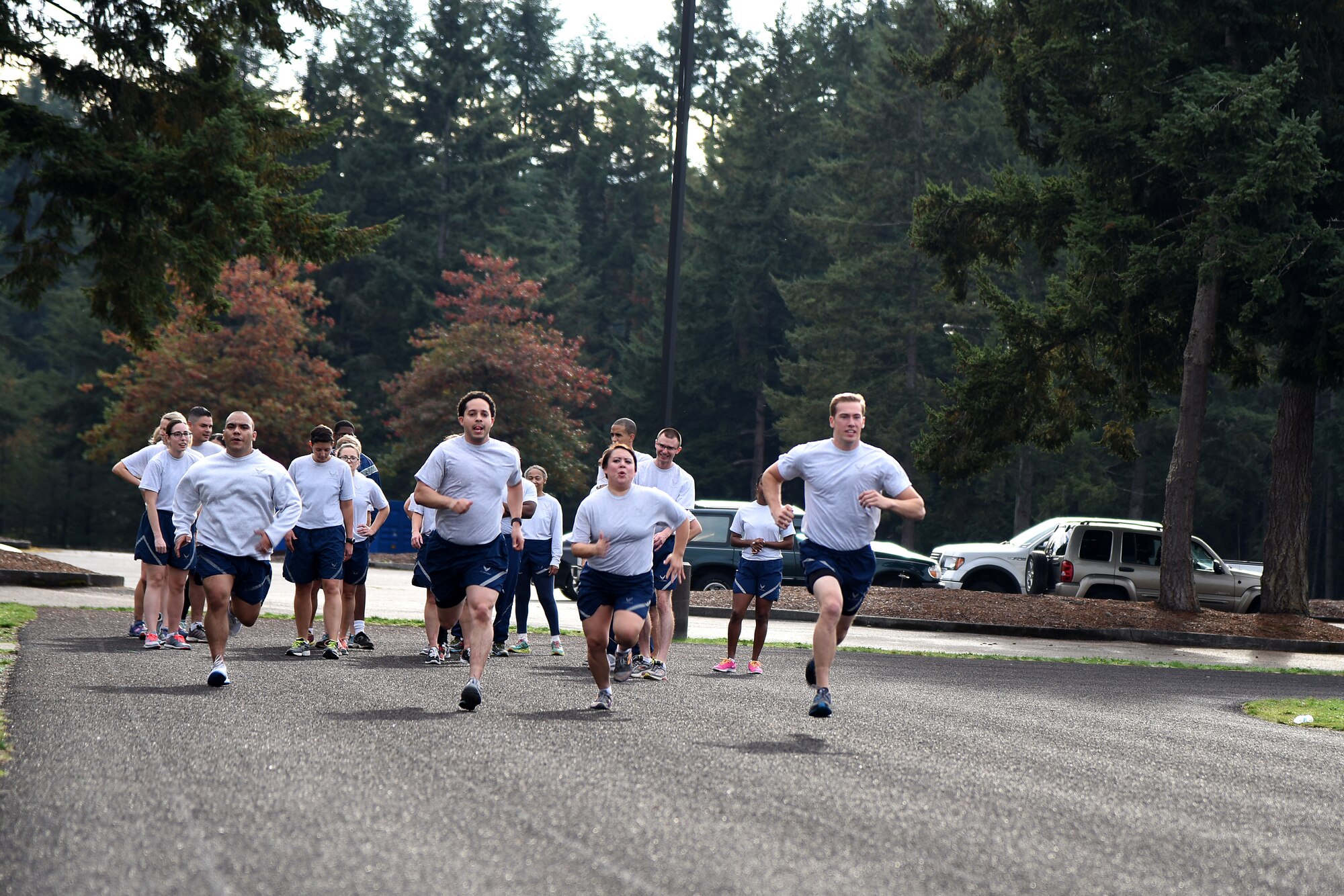 Airmen from the 62nd Medical Squadron sprint 100 meters as part of a two-mile workout, alternating sprinting and jogging, at the McChord Field outdoor track, Joint Base Lewis-McChord, Wash., Oct. 8, 2015. Staff Sgt. Don Mitchell, the 62nd MDS NCO in charge of commander support section and unit fitness program manager, has revamped their unit program to include circuit training and team building exercises, which in turn has improved their unit’s fitness assessment scores and has improved morale in regards to the squadron fitness program. (U.S. Air Force photo/Staff Sgt. Katie Jackson)