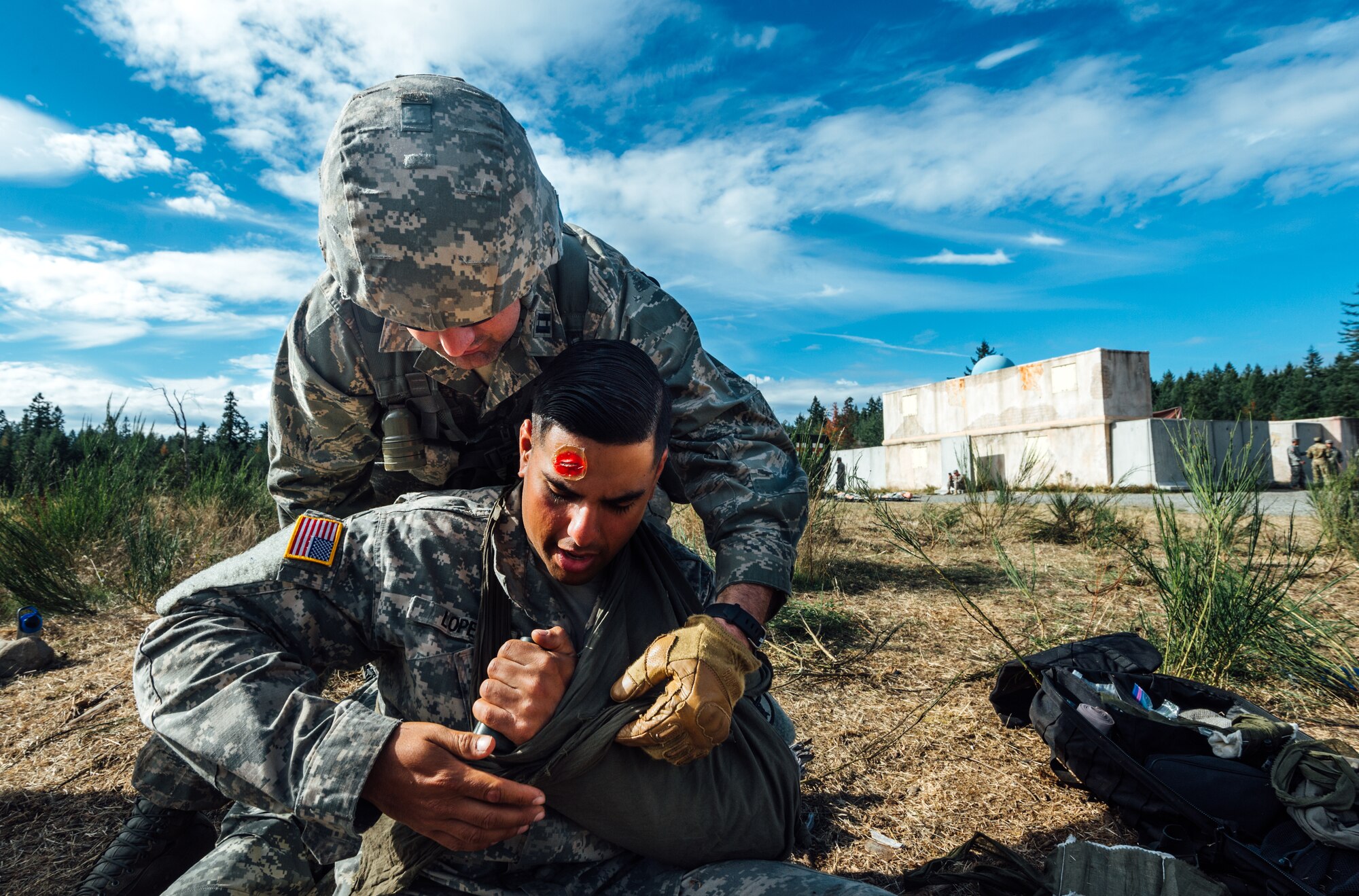 Capt. Jeffrey Mermilliod, 446th Aeromedical Staging Squadron Expert Field Medic Badge candidate, provides medical aid to a simulated causality during the EFMB course at Joint Base Lewis-McChord, Wash., Sept. 23, 2015. The EFMB is the non-combat equivalent of the Combat Medical Badge and is awarded to medical personnel of the U.S. military who successfully complete a set of qualification tests. (U.S. Air Force photo by Senior Airman Jordan Castelan/Released)