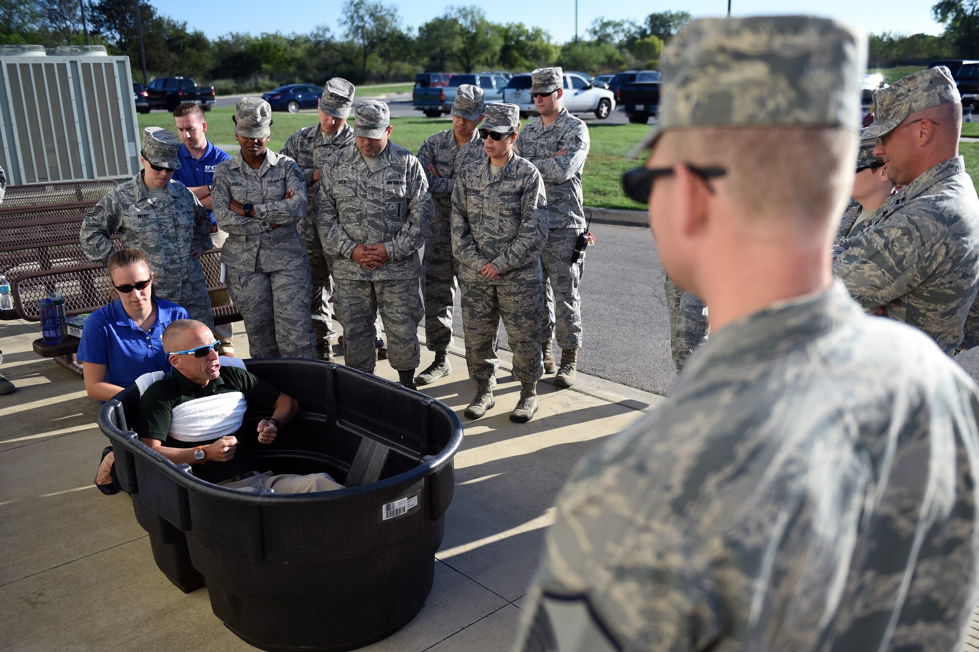 Airmen watch as Korey Stringer Institute officials Dr. Douglas Casa, Dr. Rebecca Stearns, and Luke Belval demonstrate the proper treatment for patients with heatstroke Sept. 29, 2015, at Joint Base San Antonio-Lackland. (U.S. Air Force photo/Staff Sgt. Jason Huddleston)