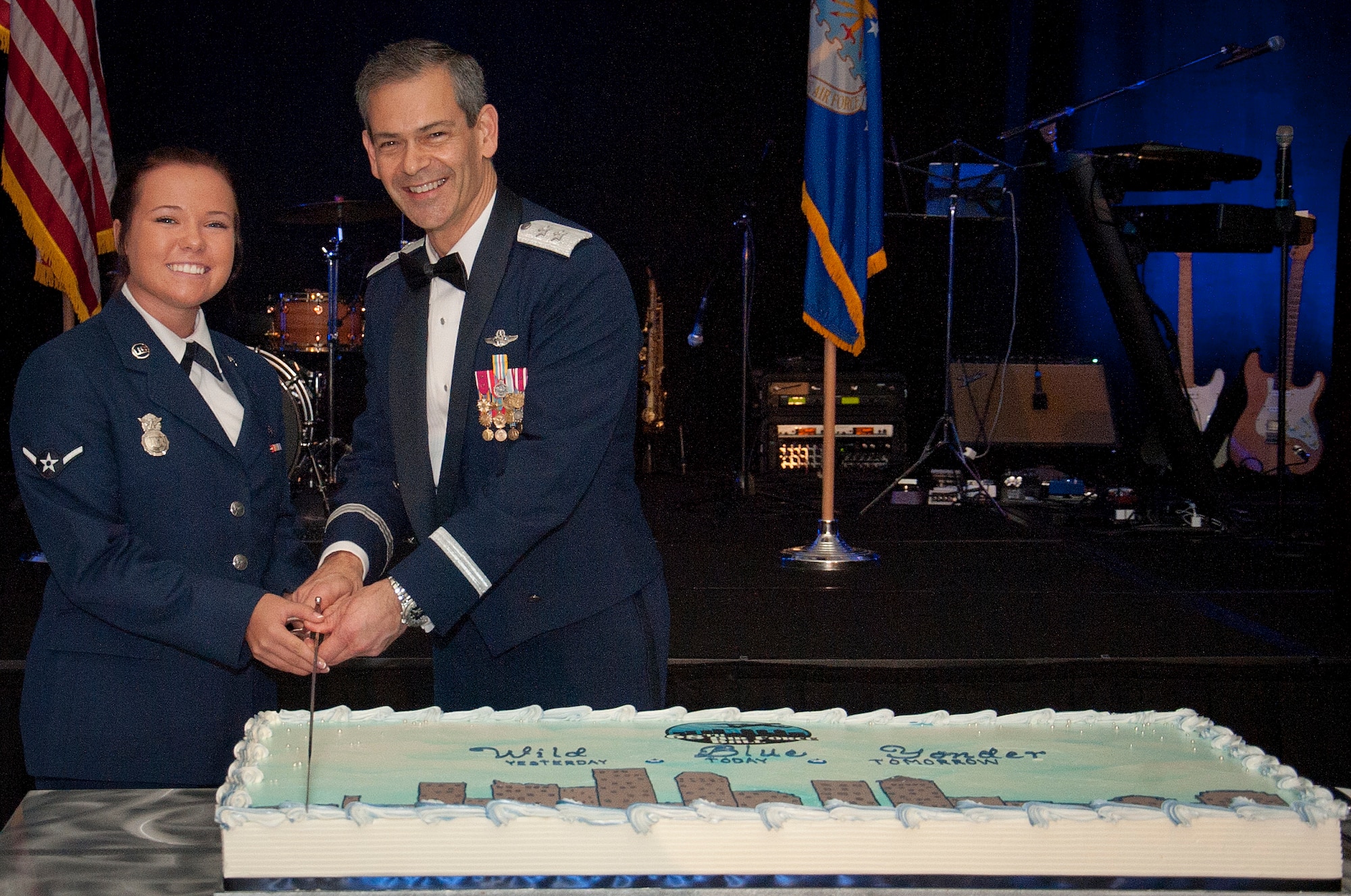Airman Deborah Lynn Wiggins, 6th Security Forces Squadron entry controller and Major Gen. Ken Wilsbach, U.S. Central Command director of operations, cut the cake Oct. 2, 2015, during the 68th Annual Air Force Ball at the Hilton Tampa Downtown in Tampa, Fla. The ball began with a social hour followed by the official ceremony that included opening remarks by Col. Daniel Tulley, 6th Air Mobility Wing commander, and Col. Randall Bright, 927th Air Refueling Wing commander, special remarks by the honorable Bob Buckhorn, mayor of Tampa, Fla., and the cutting of the cake by the youngest and oldest Airmen. (U.S. Air Force photo by Senior Airman Jenay Randolph/Released)