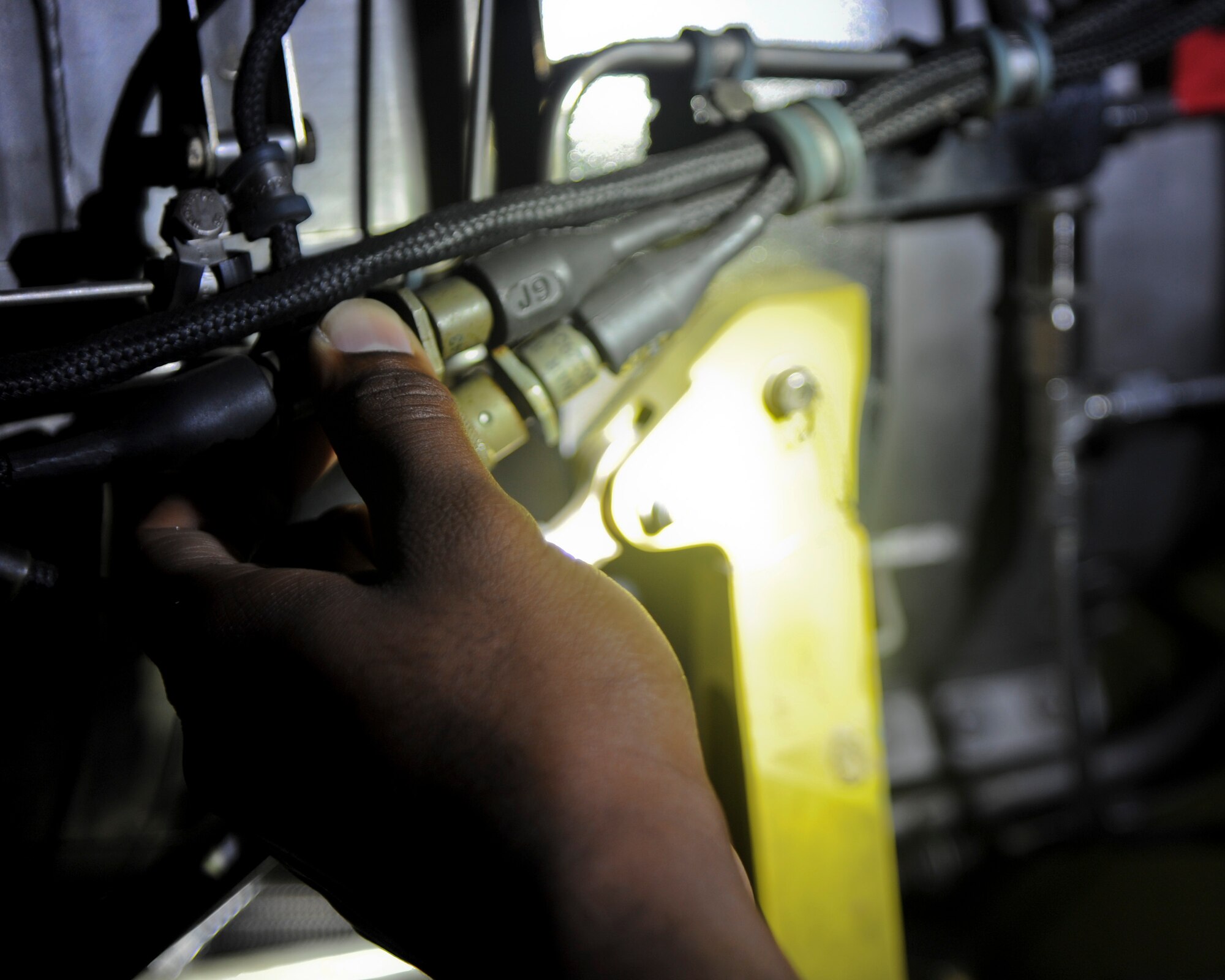 Airman 1st Class Deandre Morris, 6th Maintenance Squadron aerospace propulsion journeyman, inspects the auxiliary power unit for the KC-135 Stratotanker at MacDill Air Force Base, Fla., Oct. 7, 2015. It is important that Morris closely looks over each section of the APU to ensure the mission capability of the aircraft. (U.S. Air Force photo by Airman 1st Class Danielle Quilla/Released)