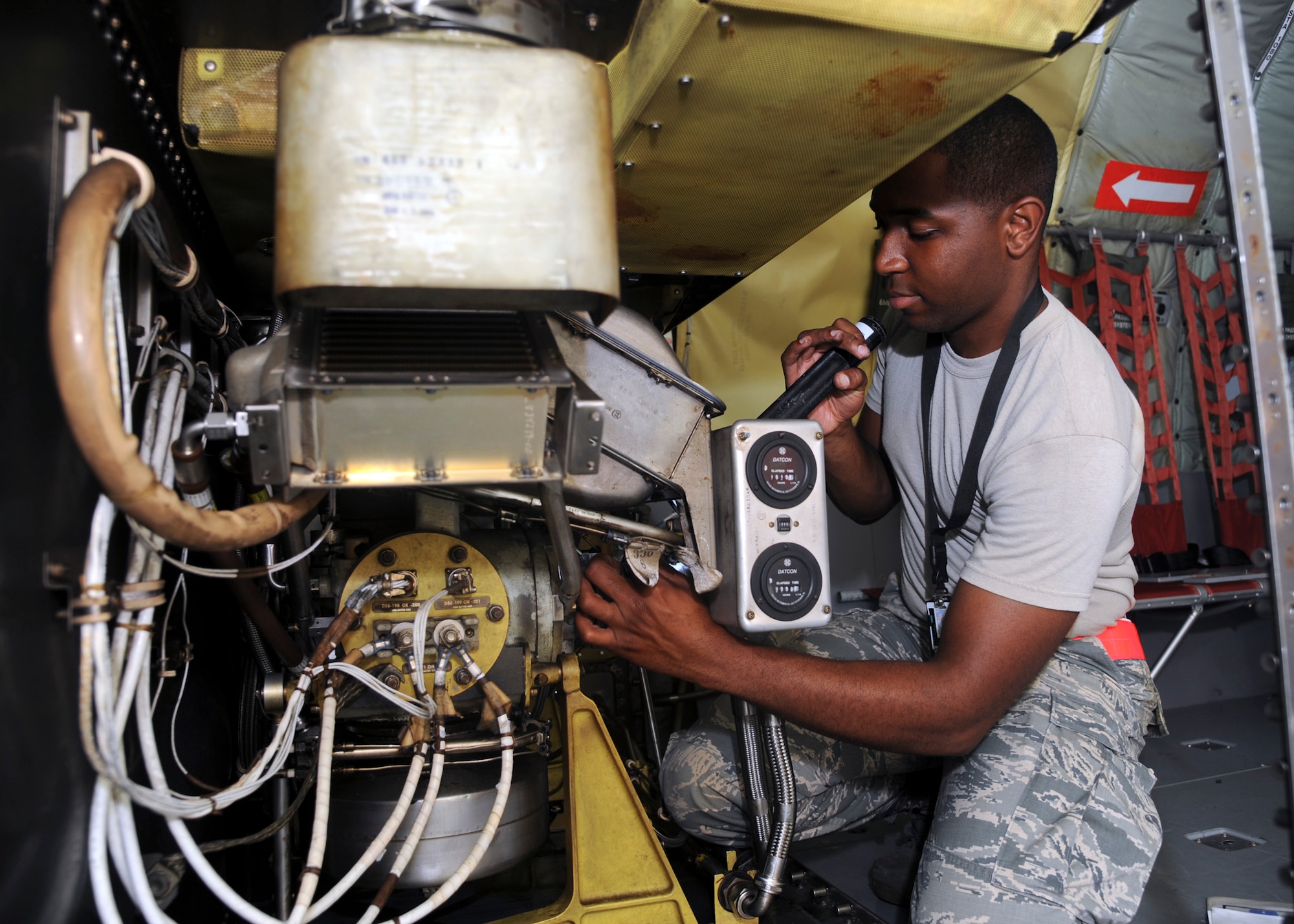Airman 1st Class Deandre Morris, 6th Maintenance Squadron aerospace propulsion journeyman, examines the auxiliary power unit for the KC-135 Stratotanker at MacDill Air Force Base, Fla., Oct. 7, 2015. The APU produces the electricity that fires up the aircraft’s engines. (U.S. Air Force photo by Airman 1st Class Danielle Quilla/Released)