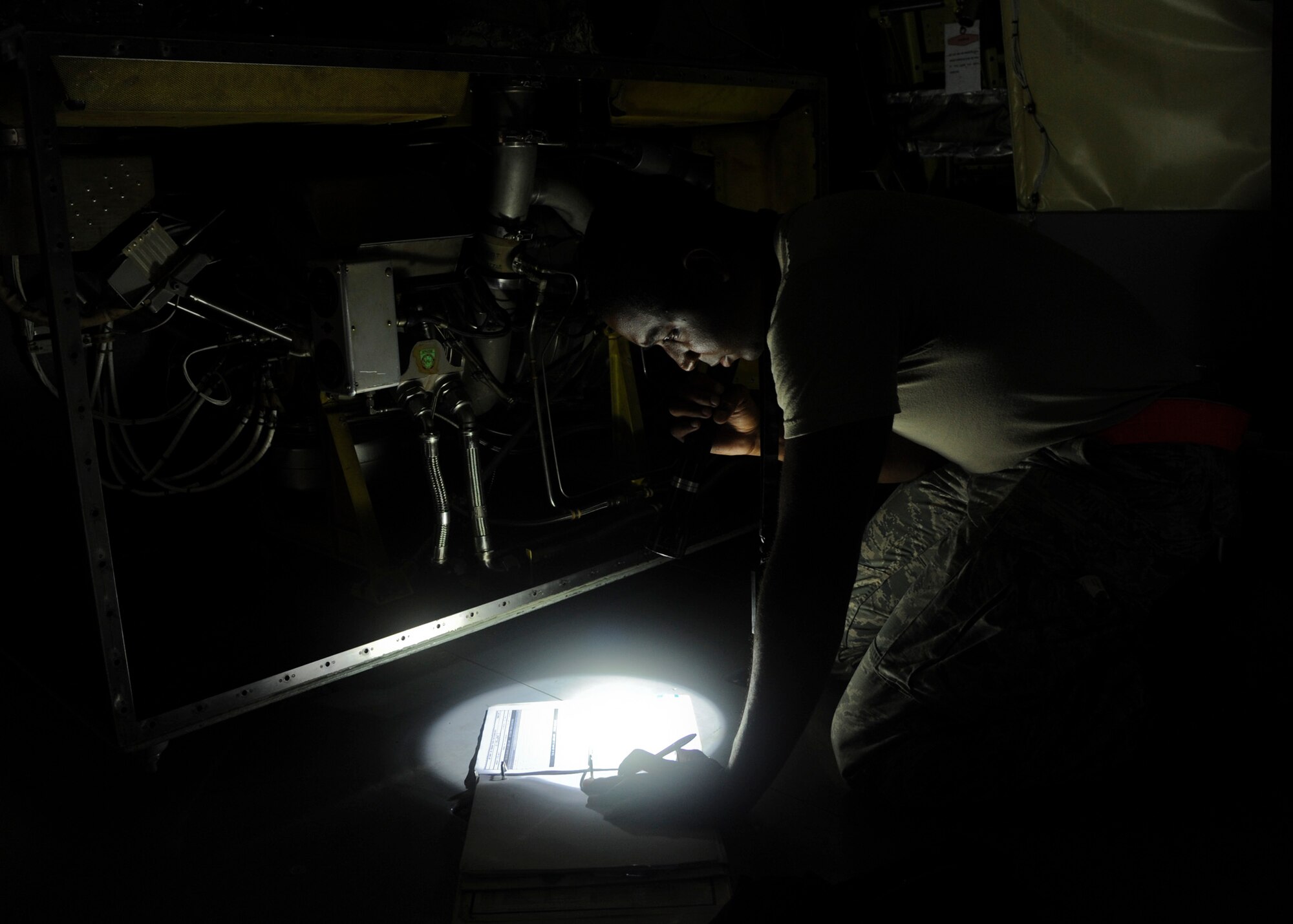 Airman 1st Class Deandre Morris, 6th Maintenance Squadron aerospace propulsion journeyman, looks over a checklist for inspecting the auxiliary power unit for the KC-135 Stratotanker at MacDill Air Force Base, Fla., Oct. 7, 2015. The checklist helps Morris ensure he does not overlook a section of the APU. (U.S. Air Force photo by Airman 1st Class Danielle Quilla/Released)