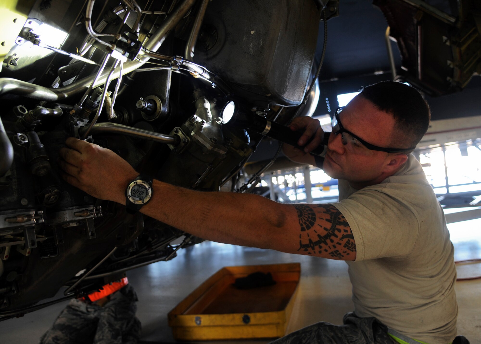 Staff Sgt. Eric Holton, 6th Maintenance Squadron aerospace propulsion craftsman, examines the main engine control of a KC-135 Stratotanker during an isochronal inspection at MacDill Air Force Base, Fla., Oct. 7, 2015. Holton uses a flashlight to clearly see the details and hidden sections of the MEC. (U.S. Air Force photo by Airman 1st Class Danielle Quilla/Released)