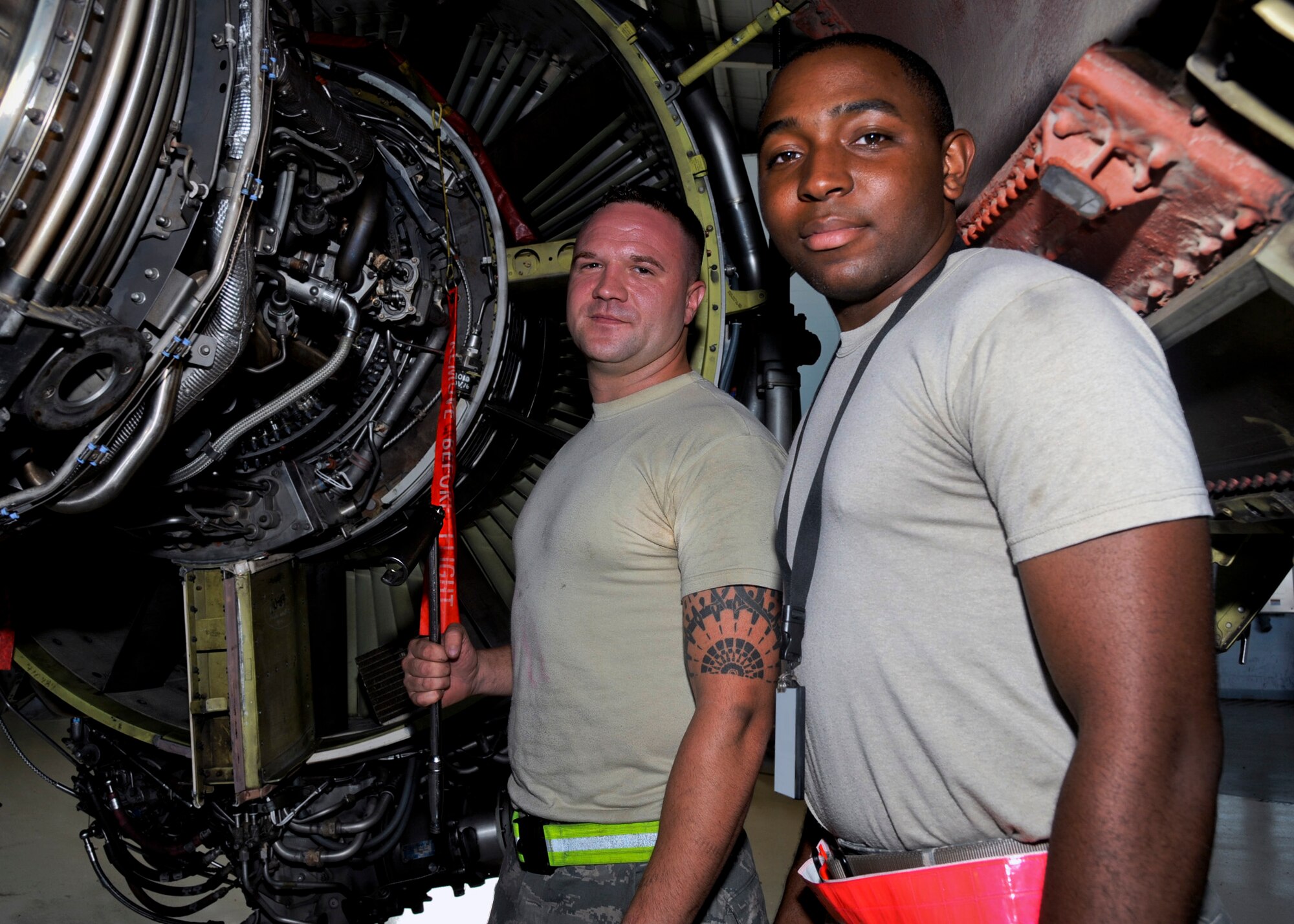 Staff Sgt. Eric Holton, 6th Maintenance Squadron aerospace propulsion craftsman, and Airman 1st Class Deandre Morris, 6th MXS aerospace propulsion journeyman, pose for a photo at MacDill Air Force Base, Fla., Oct. 7, 2015. Holton and Morris were both selected to be on the monthly Quality Assurance Honor Roll for passing multiple inspections with zero defects. (U.S. Air Force photo illustration by Airman 1st Class Danielle Quilla/Released)