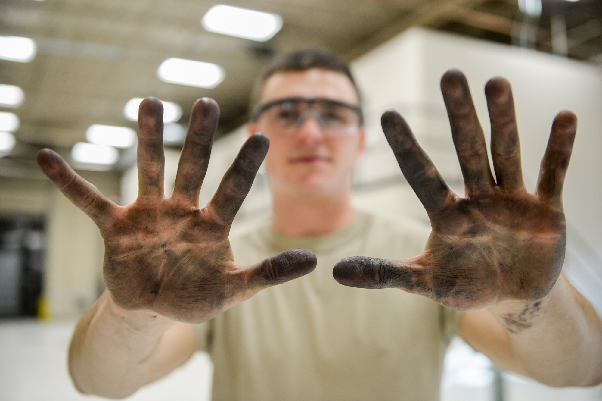 U.S. Air Force Senior Airman Cody Bowman, a 354th Maintenance Squadron aerospace propulsion journeyman, shows oil and dirt on his hands after working on an F110-GE-100C jet engine Oct. 8, 2015, during an engine rebuild in the engine shop at Eielson Air Force Base, Alaska. Bowman disassembled engine components for inspection and replacement, a process which can take several months and hundreds of man hours. (U.S. Air Force photo by Senior Airman Peter Reft/Released)