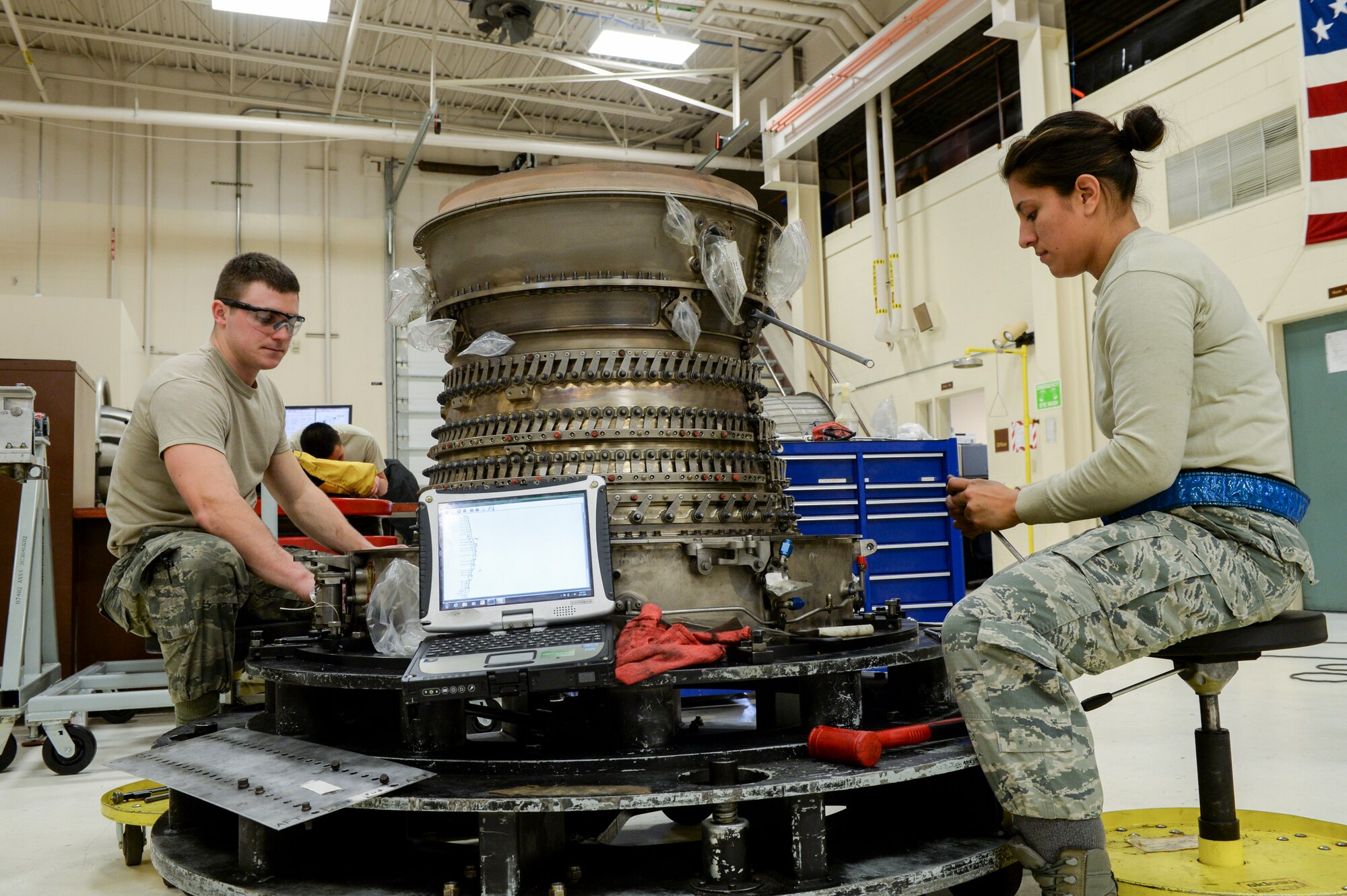 U.S. Air Force Senior Airman Cody Bowman, an aerospace propulsion journeyman, and Staff Sgt. Catalina Cornejo, an aerospace propulsion craftsman, both assigned to the 354th Maintenance Squadron, disassemble an F110-GE-100C jet engine Oct. 8, 2015, during an engine rebuild in the engine shop at Eielson Air Force Base, Alaska. Bowman and Cornejo conducted an engine rebuild to find and replace any worn components. (U.S. Air Force photo by Senior Airman Peter Reft/Released)  