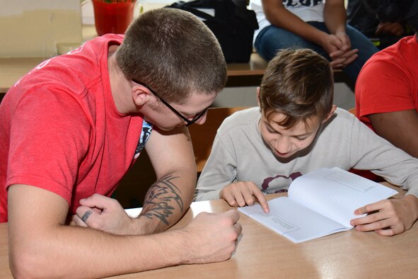 U.S. Air Force Senior Airman Josh Williams, left, maintenance operations center production controller with the Wisconsin Air National Guard's 115th Fighter Wing engages with Polish students at Gimnazjum NR 1 middle school in Konstantynów Łódzki, Poland, Sept. 11, 2015. The visit was part of a cultural exchange between the school's students, and the Airmen deployed in support of U.S. Aviation Detachment Rotation 15-4 at Łask Air Base. Through the National Guard State Partnership Program, the 115th Fighter Wing has established an enduring relationship with the 10th Fighter Squadron at Łask, to include engaging in community relations activities in nearby Polish communities. (U.S. Air National Guard Photo by Master Sgt. Paul Gorman/Released)