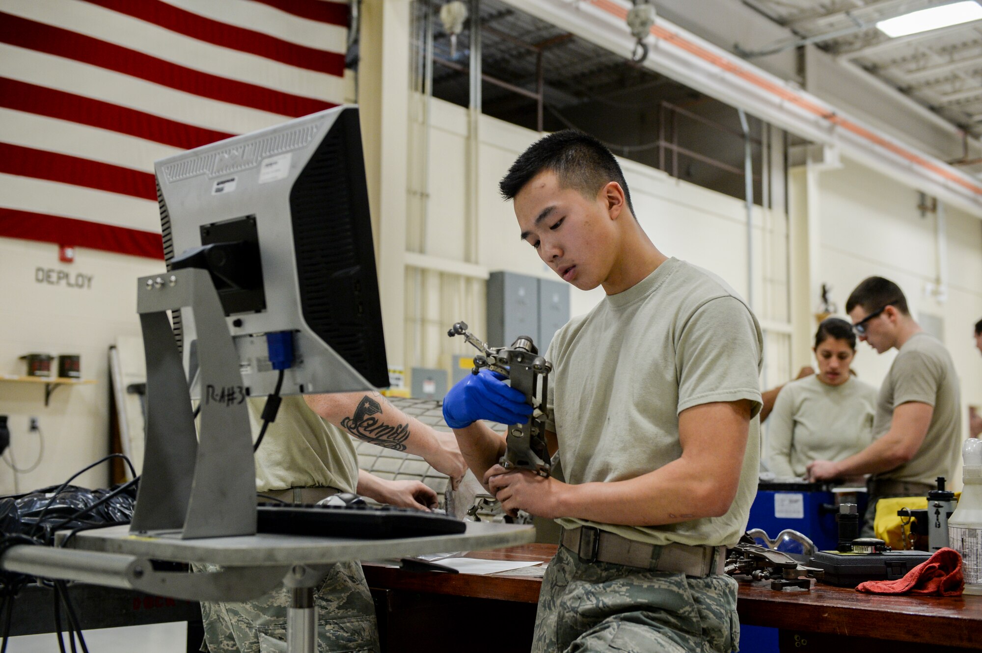 U.S. Air Force Airman 1st Class Brandon Trang, a 354th Maintenance Squadron aerospace propulsion apprentice, inspects parts for damage Oct. 8, 2015, during an engine rebuild in the engine shop at Eielson Air Force Base, Alaska. Trang ensured components were safe for continued use and tracked the condition of each part. (U.S. Air Force photo by Senior Airman Peter Reft/Released)
