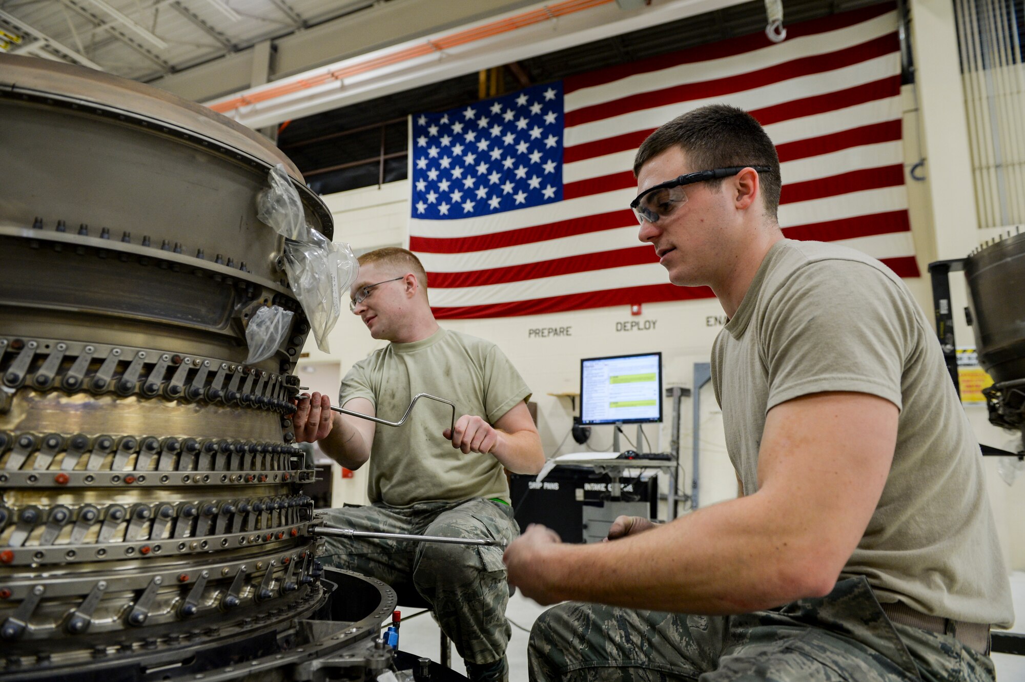 U.S. Air Force Senior Airmen Andrew Piercy and Cody Bowman, both 354th Maintenance Squadron aerospace propulsion journeymen, disassemble an F110-GE-100C engine compressor Oct. 8, 2015, in the engine shop at Eielson Air Force Base, Alaska.  Piercy and Bowman were involved in an aircraft engine rebuild, a detail-demanding process that can take several months to complete.  (U.S. Air Force photo by Senior Airman Peter Reft/Released)
