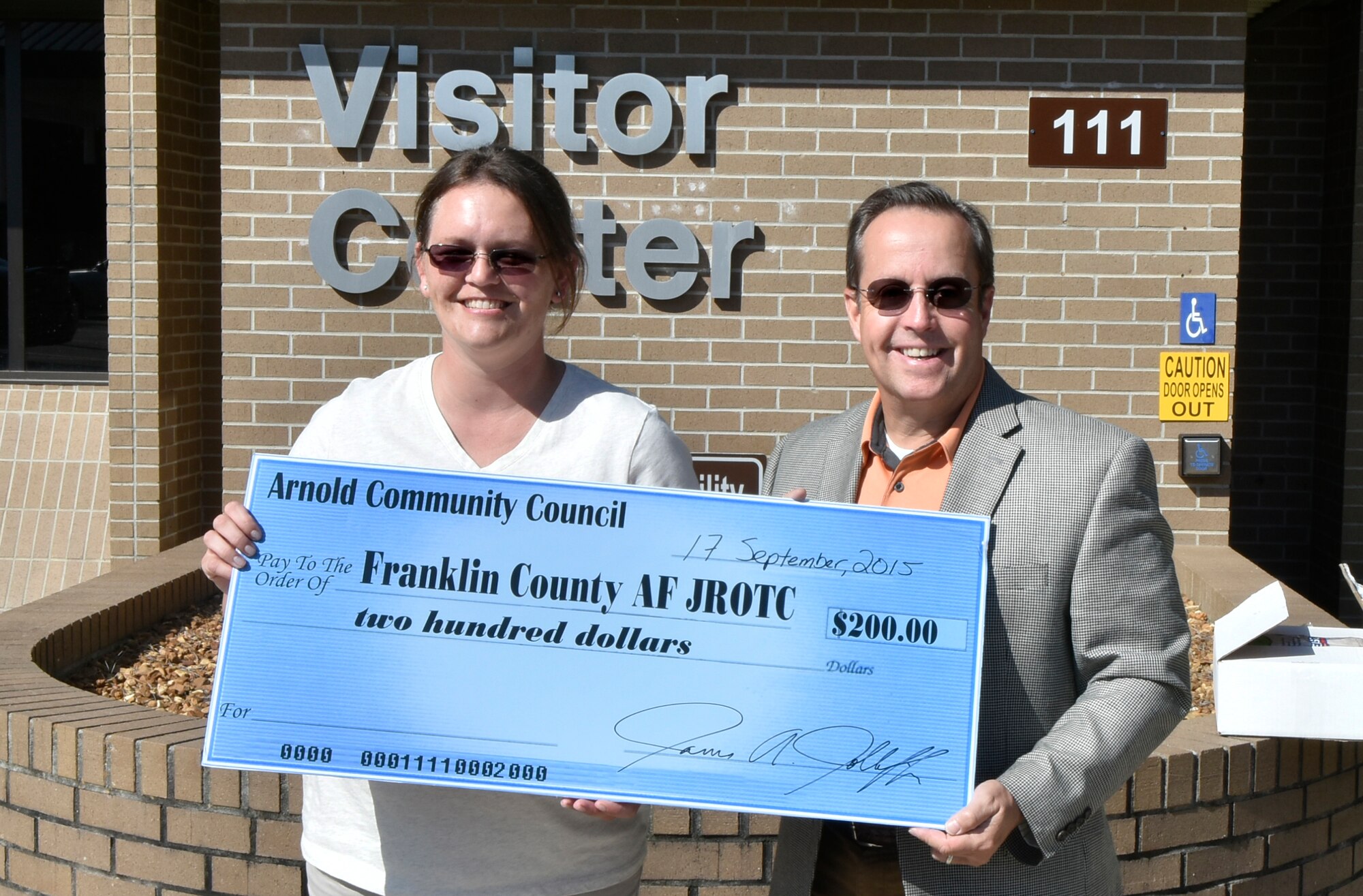 A donation was recently presented by the Arnold Community Council to assist the Franklin County Air Force Junior Reserve Officer's Training Corps in providing cadets with materials for the new school year. Pictured is Julie Campbell, AF JROTC parent volunteer, accepting a check from ACC President Jim Jolliffe.