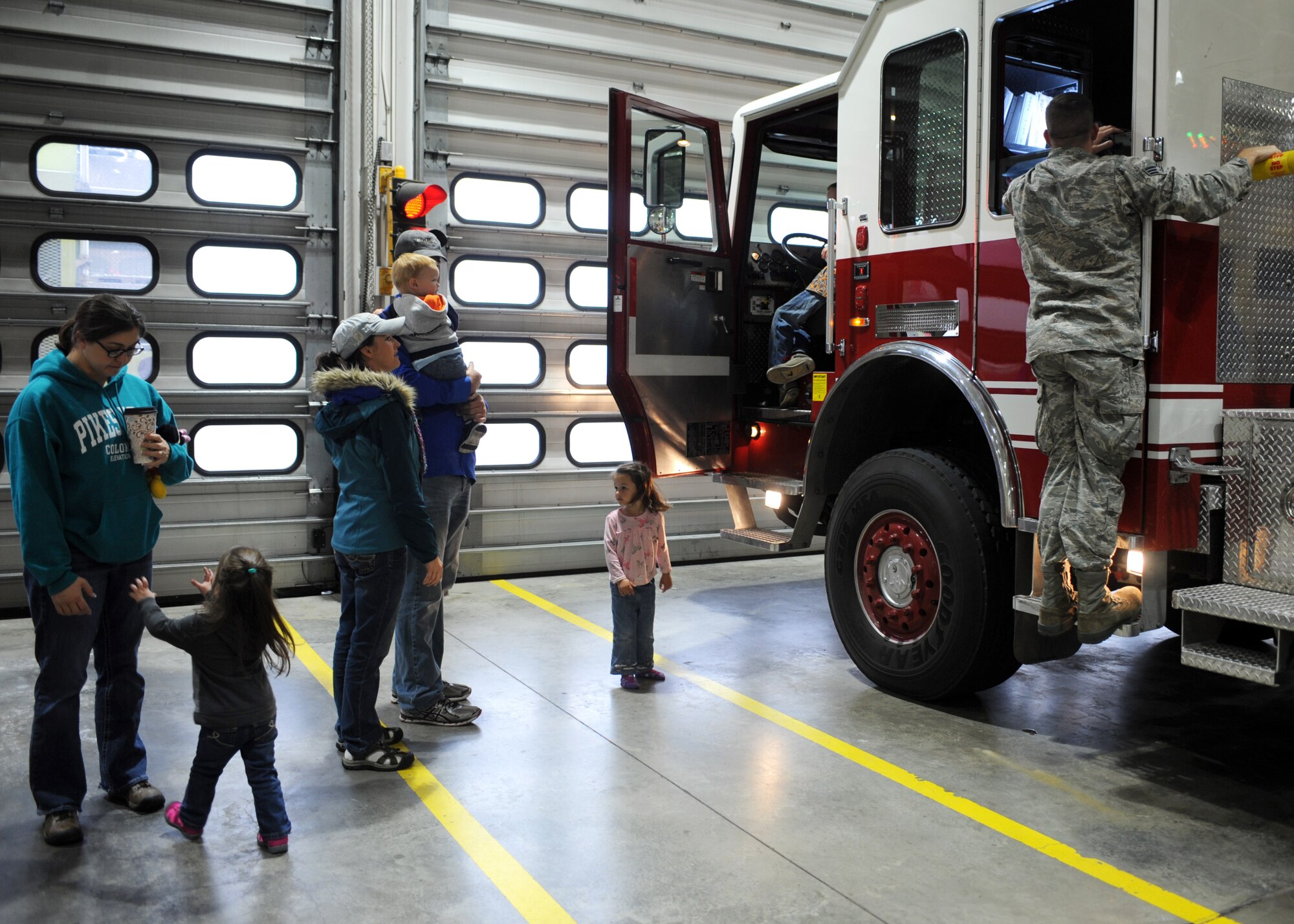 Families tour a fire truck during the Fire Prevention Week parade and open house at Ellsworth Air Force Base, S.D., Oct. 3, 2015. Fire Prevention Week is observed during the week of Oct. 9 and is hosted by the National Fire Protection Association. (U.S. Air Force photo by Airman 1st Class Denise M. Nevins/Released)