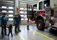 Families tour a fire truck during the Fire Prevention Week parade and open house at Ellsworth Air Force Base, S.D., Oct. 3, 2015. Fire Prevention Week is observed during the week of Oct. 9 and is hosted by the National Fire Protection Association. (U.S. Air Force photo by Airman 1st Class Denise M. Nevins/Released)