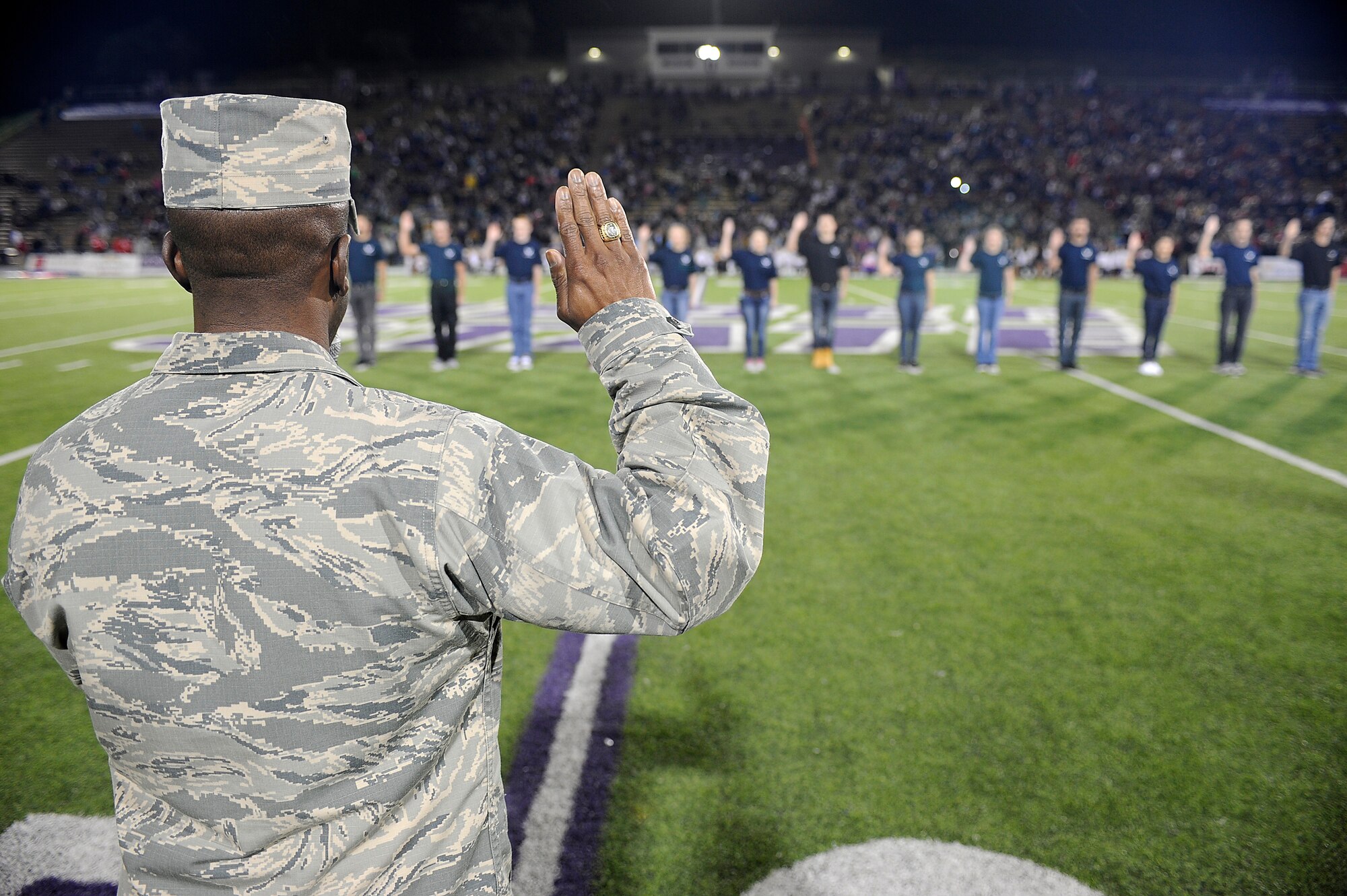 Col. Ron Jolly, 75th Air Base Wing commander, gives the oath of enlistment to 17 Air Force recruits Oct. 2 during halftime of a football game at Stewart Stadium, Weber State University, Ogden, Utah. WSU invited Team Hill personnel to the game with Southern Utah University in recognition of the strong relationship between the school and Hill Air Force Base. SUU won the game 44-0. (U.S. Air Force photo by Paul Holcomb)