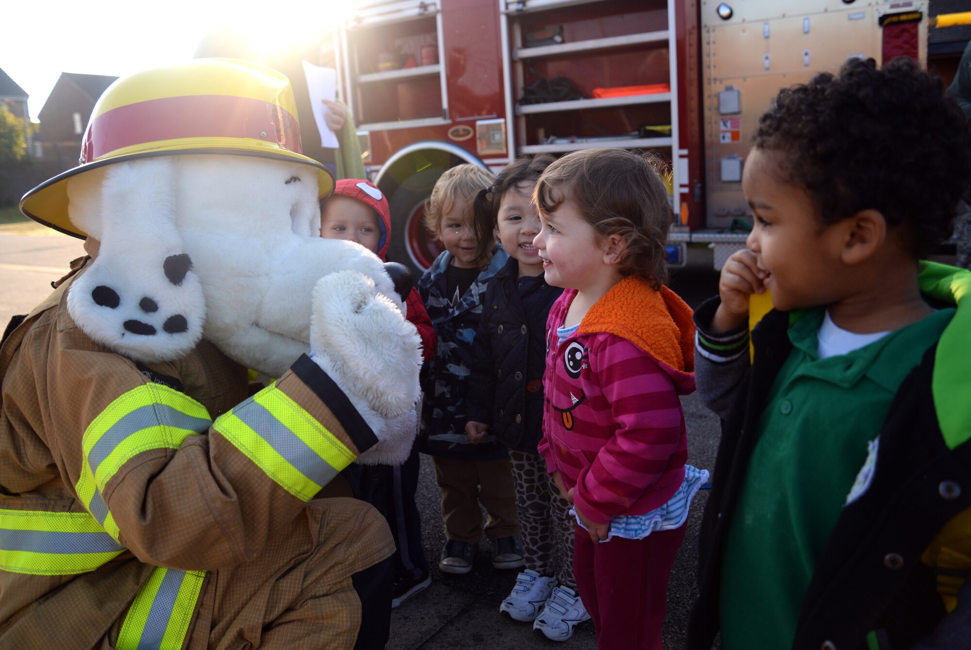 Sparky the Fire Dog, 100th Civil Engineer Squadron Fire Department mascot, greets children Oct. 9, 2015, on RAF Mildenhall, England. The 100th CES Fire Department visited the 100th Force Support Squadron Child Development Center and youth center to educate children as part of Fire Prevention Week.  (U.S. Air Force photo by Senior Airman Christine Halan/Released) 