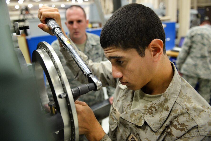 Royal Saudi Air Force airman Abdulgader Baeraqi, 361st Training Squadron aerospace propulsion apprentice course graduate, gets some hands-on practice working on the General Electric F-110 jet engine during class hours before his final examination, Oct. 1, 2015, at Sheppard Air Force Base, Texas.  Baeraqi spent some time in the English Language Training course before beginning the three-month technical school. (U.S. Air Force photo/Tech. Sgt. Mike Meares)