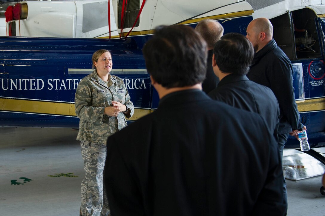 Capt. Carly Kayser, 1st Helicopter Squadron pilot, answers questions about the UH-1N Huey during a tour of the 1st HS Oct. 7, 2015 at Joint Base Andrews, Md. Ten priests from all over the U.S. visited JBA as part of a familiarization visit to each branch of the military put on by the Archdiocese for the Military Services. (Air Force photo by Senior Airman Dylan Nuckolls/Released)