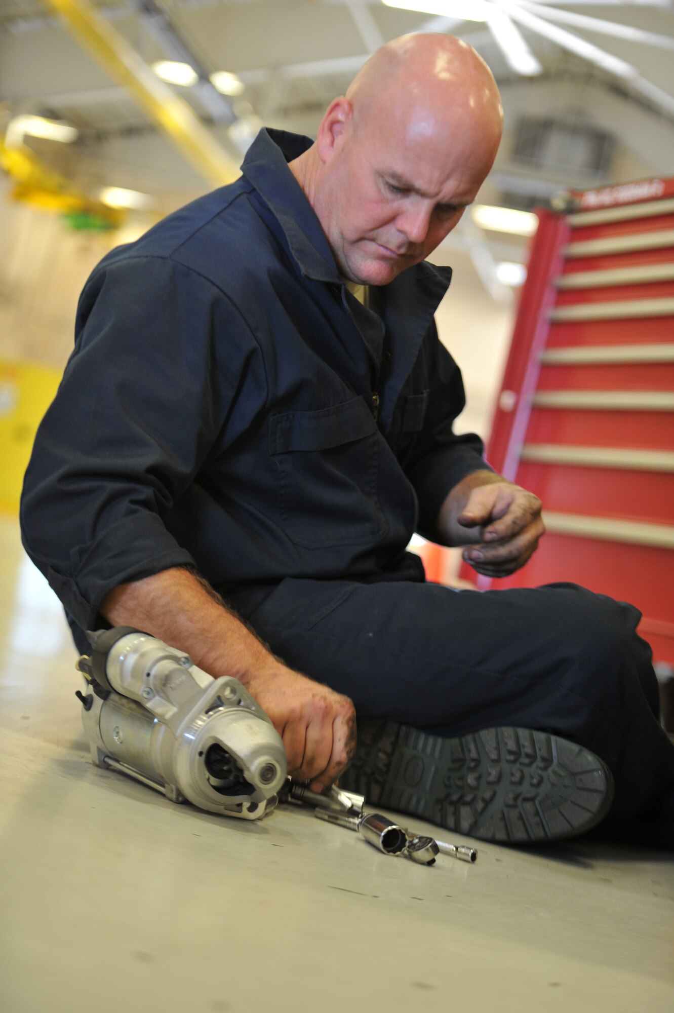 Tech. Sgt. Greg Alexander, 325th Maintenance Squadron aerospace ground equipment technician craftsman, assembles a starter component for a bomblift truck Oct. 9 at the AGE repair shop. The AGE flight mission is to maintain the serviceability and operability of 805 pieces of ground support equipment that directly supports 55 F-22s, 18 T-38s, 4 QF 4s, all incoming Transient Alert aircraft, and all Weapon System Evaluation Program exercises. (U.S. Air Force photo by Senior Airman Ty-Rico Lea/Released)