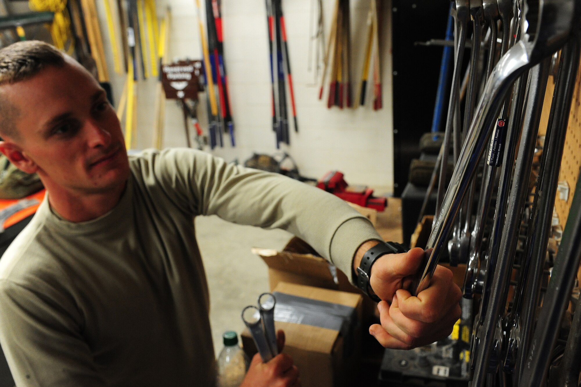 Senior Airman Kalen Dozzi, 509th Civil Engineer Squadron pavement and equipment journeyman, gathers wrenches for equipment repair at Whiteman Air Force Base, Mo., Oct. 5, 2015. The pavement and equipment shop relies on tools, such as wrenches, jack hammers, hydraulic jacks and more, to repair equipment or perform pavement maintenance. (U.S. Air Force photo by Senior Airman Keenan Berry/Released)