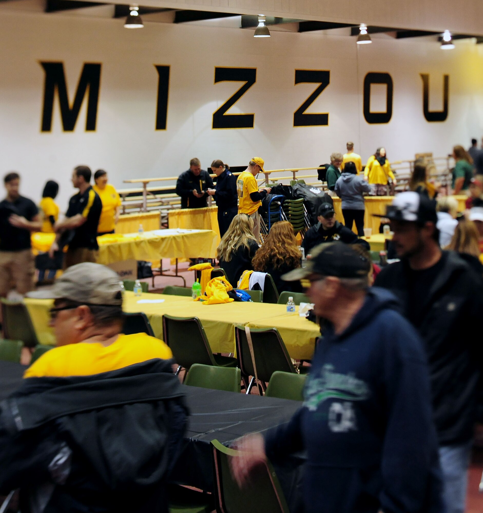 Members from Team Whiteman attend a free “tailgate” event at the Hearnes Fieldhouse Oct. 3, 2015, in Columbia, Mo. The tailgate event at the University of Missouri offered food, drinks and commemorative military appreciation day shirts for service members and their families. Entertainment was provided by the MU cheerleaders, golden girls and the Marching Mizzou band. (U.S. Air Force photo by Airman 1st Class Jazmin Smith/Released)