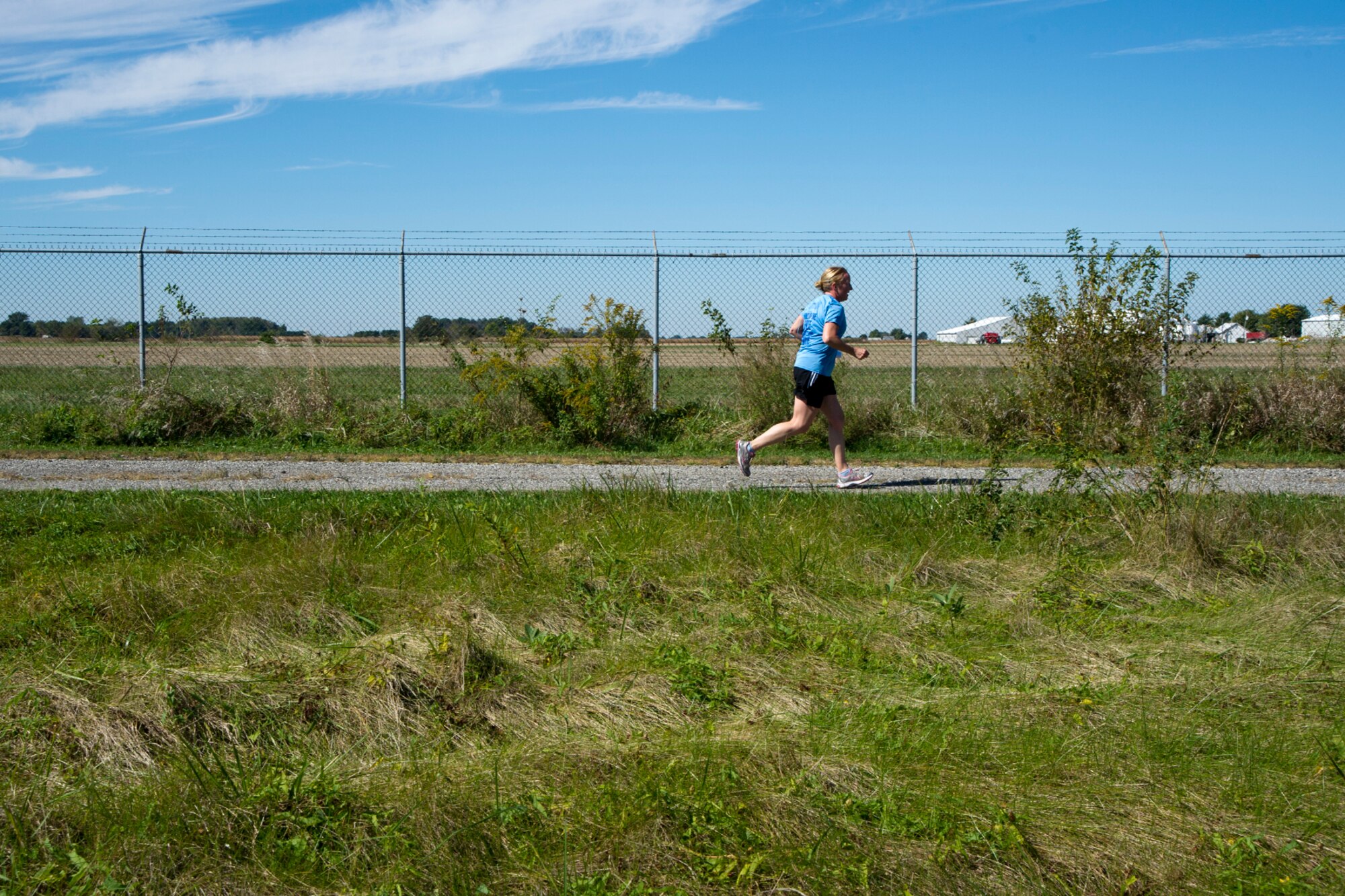 Therese Kern, 434th Aerospace Medical Squadron commander, takes a long stride during a Fall Foliage 5K and walk at Grissom Air Reserve Base, Ind., Sept. 30, 2015. Twenty Airmen participated in the event to celebrate the beginning of autumn. (U.S. Air Force photo/Senior Airman Katrina Heikkinen)