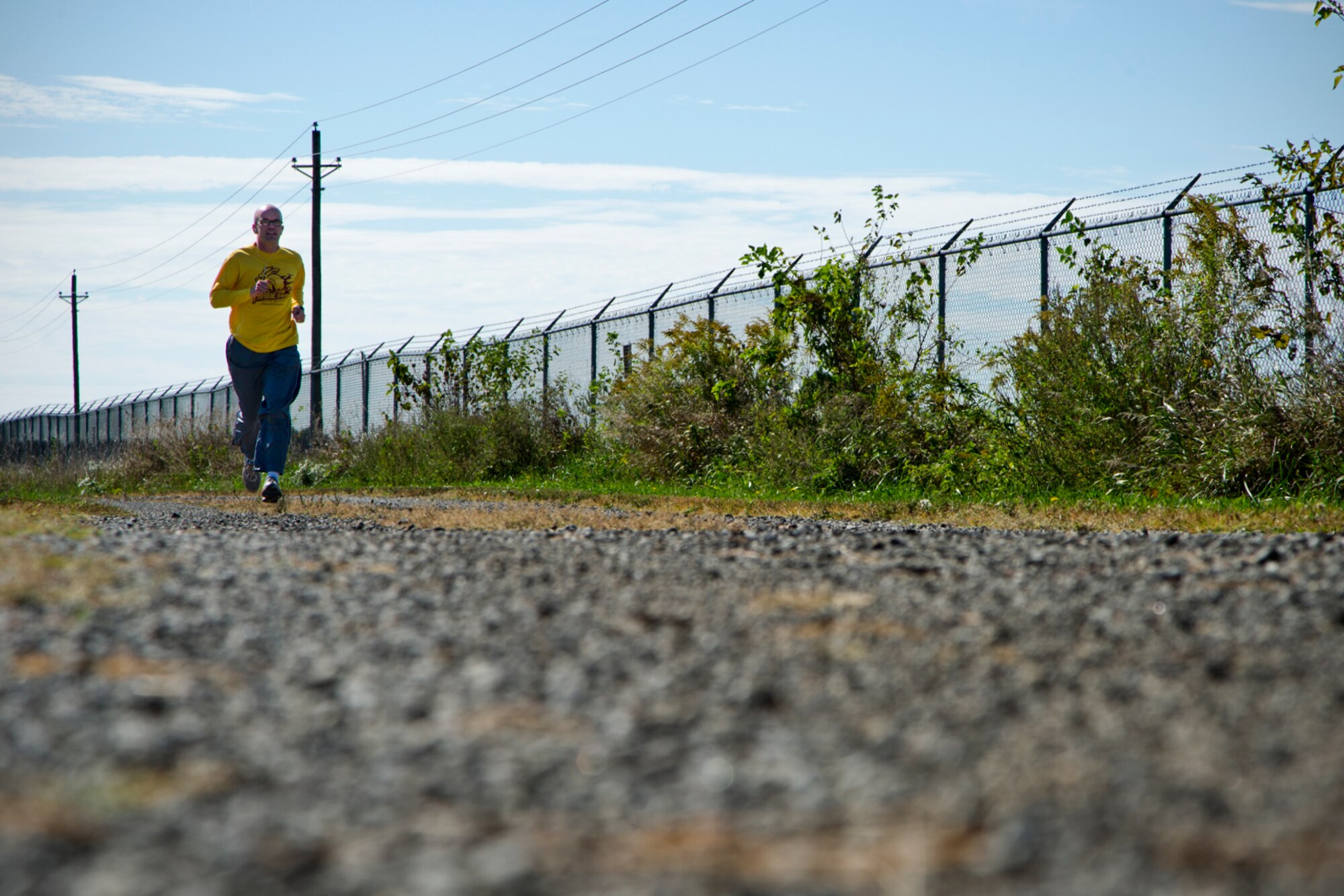 James Gutzman, 434th Air Refueling Wing staff judge advocate, runs along the western perimeter of base during a Fall Foliage 5K at Grissom Air Reserve Base, Ind., Sept. 30, 2015. Hosted by the 434th Force Support Squadron fitness center, the 3.1-mile fun run provided an outlet for Airmen to pursue cardiovascular fitness, a component of the Air Force fitness assessment. (U.S. Air Force photo/Senior Airman Katrina Heikkinen) 