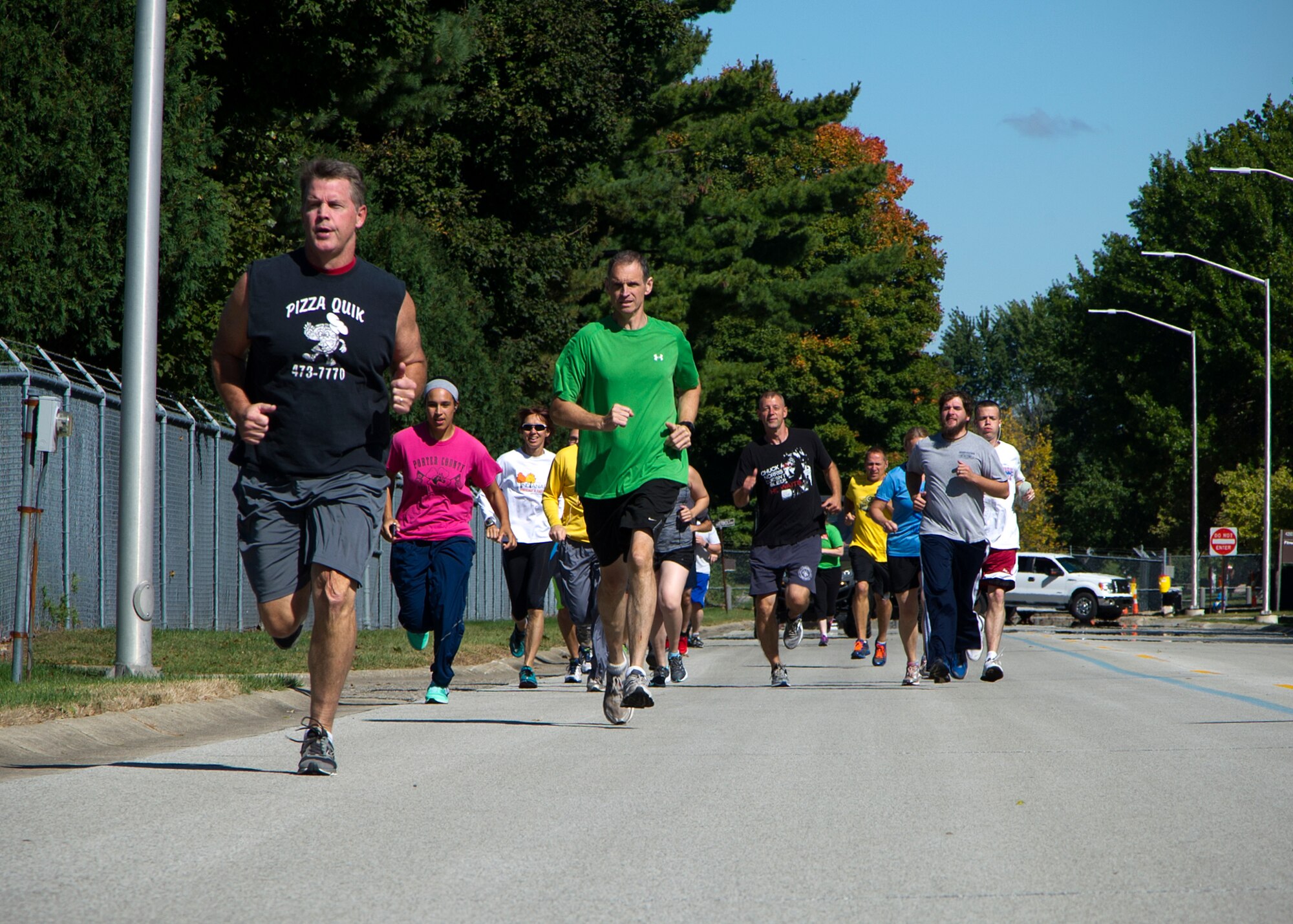 Twenty Grissom Airmen set a fast pace at the start of a Fall Foliage 5K and walk at Grissom Air Reserve Base, Ind., Sept. 30, 2015. The event was hosted by 434th Force Support Squadron fitness center to promote fun and fitness. (U.S. Air Force photo/Senior Airman Katrina Heikkinen)