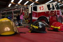 U.S. Air Force Airman 1st Class Ty Hults, a 52nd Civil Engineer Squadron firefighter, lets Bitburg Elementary School students climb inside a fire truck during a visit to BES on Bitburg Annex, Germany, Oct. 8, 2015. U.S. Air Force Col. Joe McFall, 52nd Fighter Wing commander, proclaimed Oct. 4-10 as Fire Prevention Week which included school visits and fire-safety demonstrations in front of the Exchange by the Spangdahlem Fire Department. (U.S. Air Force photo by Airman 1st Class Luke J. Kitterman/Released)