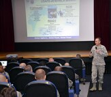 U.S. Air Force Col. Scott Arcuri, U.S. Air Forces in Europe-Air Forces Africa director of manpower, personnel and services, talks to Team Mildenhall members about the USAFE-AFAFRICA mission, leadership, stratification and promotion at an all call Oct. 7, 2015, on RAF Mildenhall, England. Arcuri visited Team Mildenhall to meet with base leadership and Airmen, and answer questions and concerns. (U.S. Air Force photo by Karen Abeyasekere/Released) 