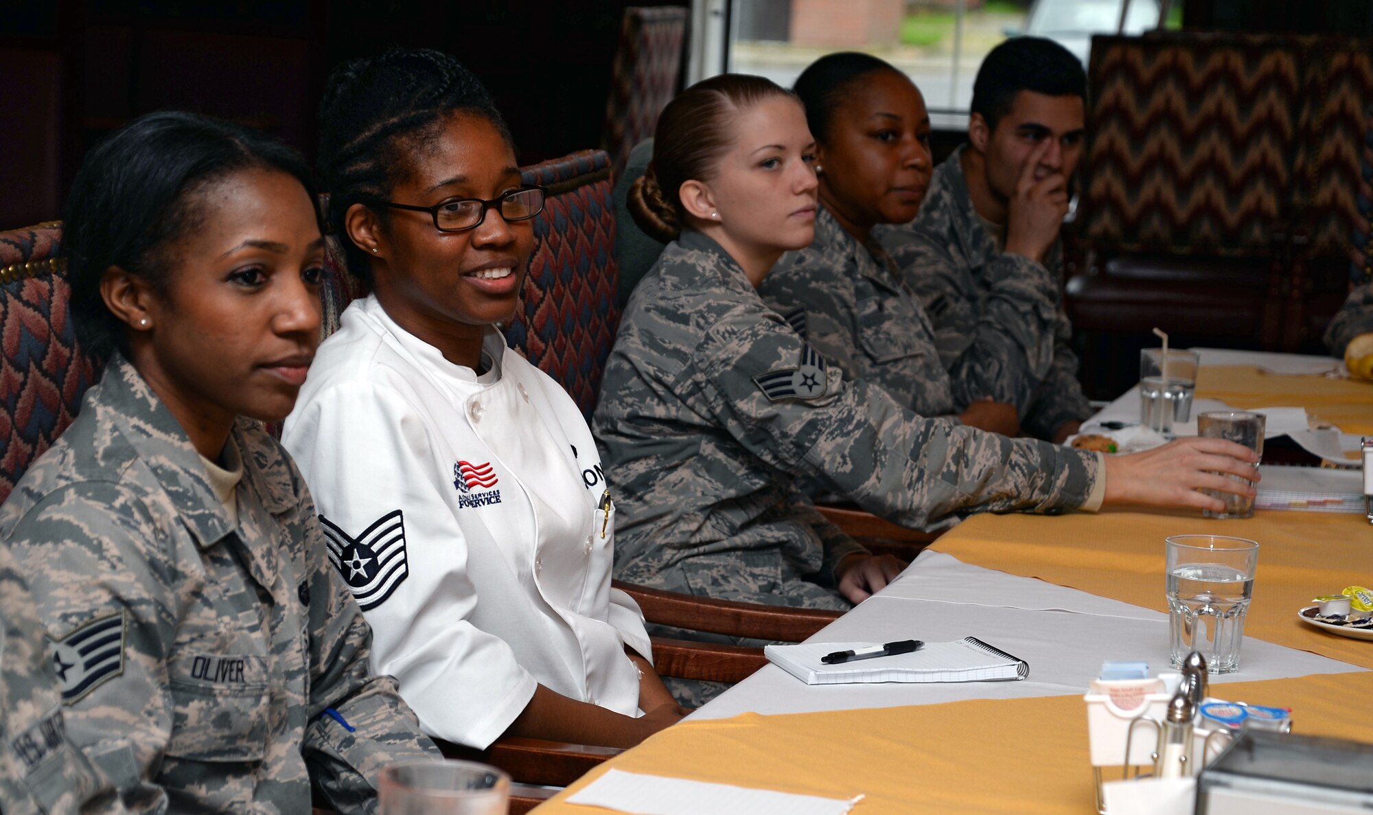 Command Support Staff Airmen from Team Mildenhall listen while other Airmen introduce themselves during a luncheon with U.S. Air Force Col. Scott Arcuri, U.S. Air Forces in Europe and Air Forces Africa director, manpower, personnel, services Oct. 6, 2015, on RAF Mildenhall, England. Arcuri visited the CSS Airmen to answer their questions about day-to-day job issues. (U.S. Air Force photo by Senior Airman Christine Halan/Released)