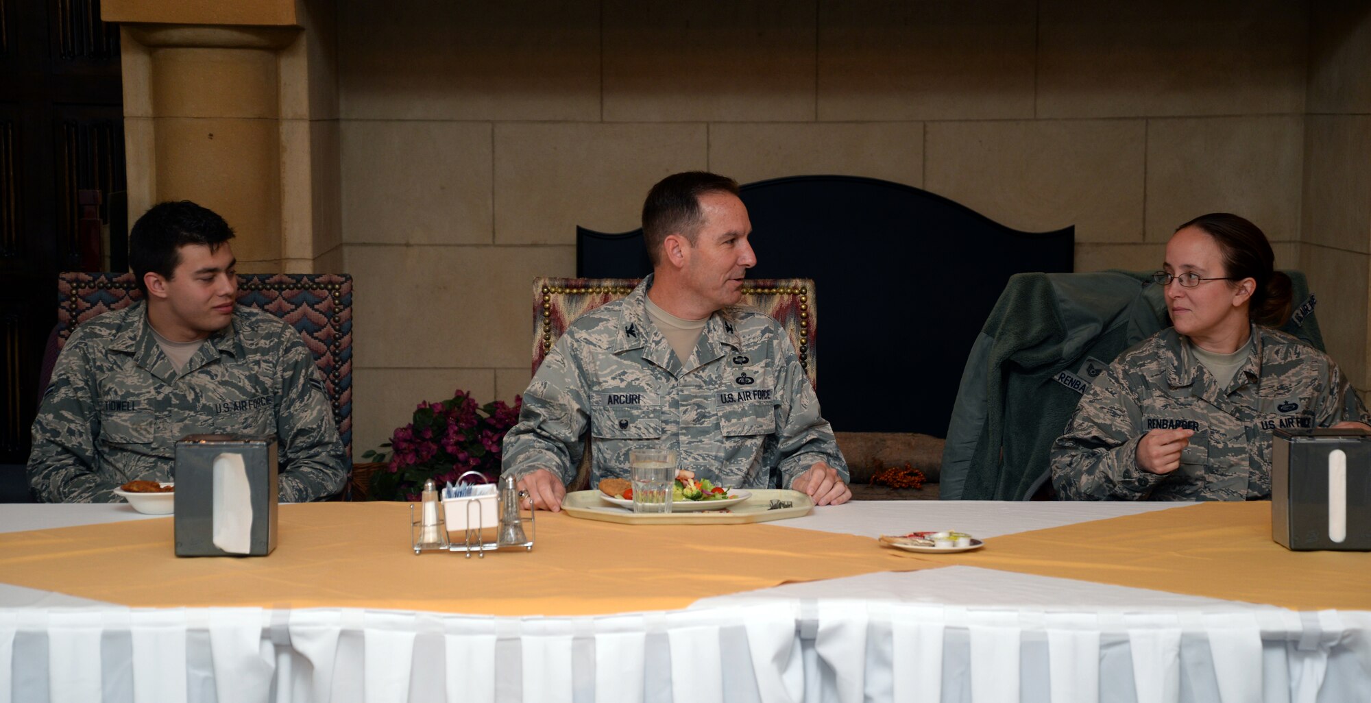 U.S. Air Force Col. Scott Arcuri, center, U.S. Air Forces in Europe and Air Forces Africa  director, manpower, personnel, services, asks U.S. Air Force Tech. Sgt. Kathryn Renbarger, 752nd Special Operations Group executive assistant, to begin introductions during his lunch visit with command support staff Airmen, Oct. 6, 2015, on RAF Mildenhall, England. Arcuri visited the CSS Airmen to answer their questions about day-to-day job issues. (U.S. Air Force photo by Senior Airman Christine Halan/Released)
