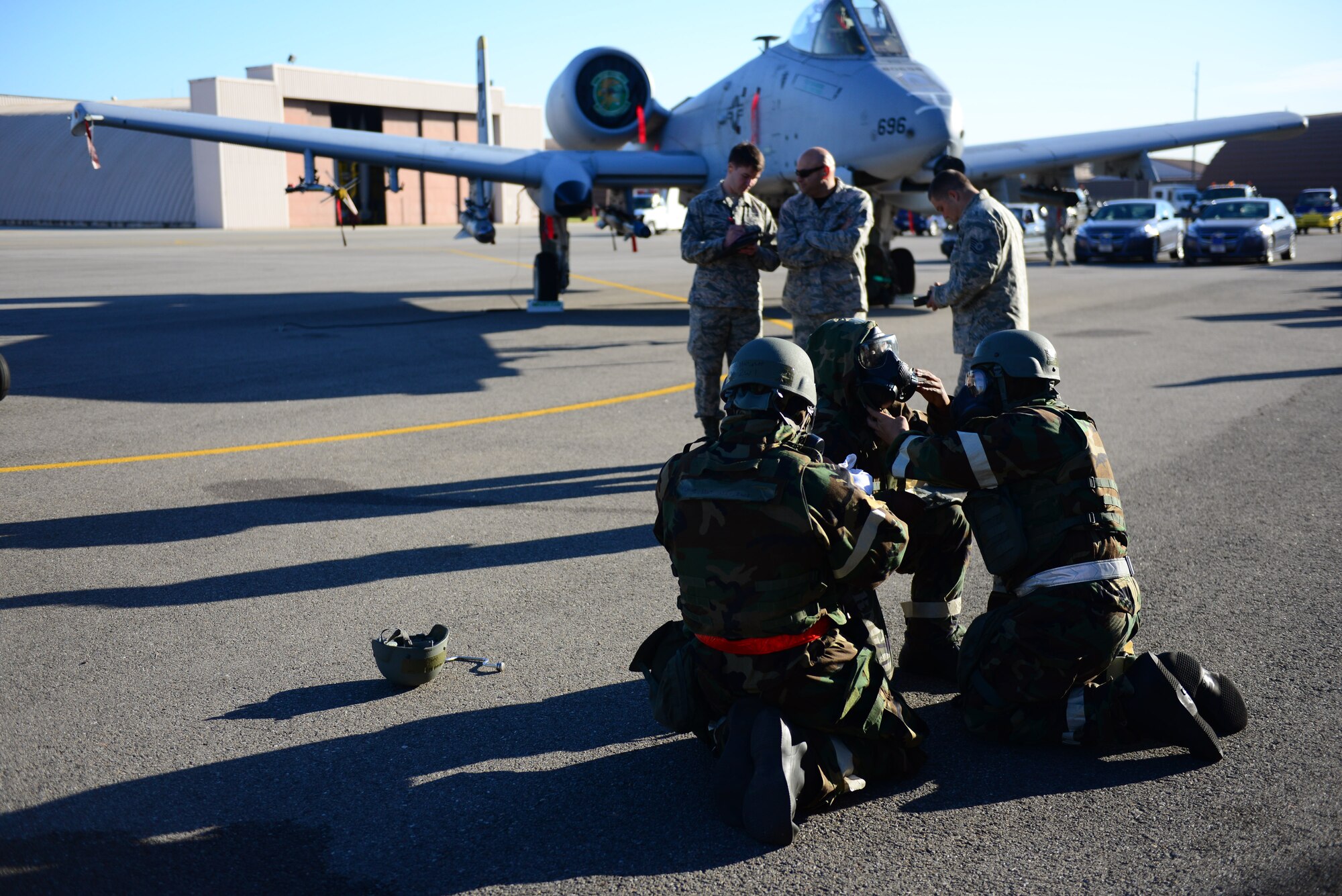 The 36th Aircraft Maintenance Unit load team performs buddy checks as a simulated gas attack is called in the middle of the quarterly load competition held at Osan Air Base, Republic of Korea, Oct. 9, 2015. As part of their monthly qualification standards, weapons load crews from the 36th and 25th Aircraft Maintenance Units   go head-to-head, once a quarter, reloading either an F-16 Fighting Falcon or an A-10 Thunderbolt II.  Each crew completes a written standards test and is timed when they reload simulated munitions onto their respective aircraft. 
(U.S. Air Force photo/Staff Sgt. Amber Grimm)