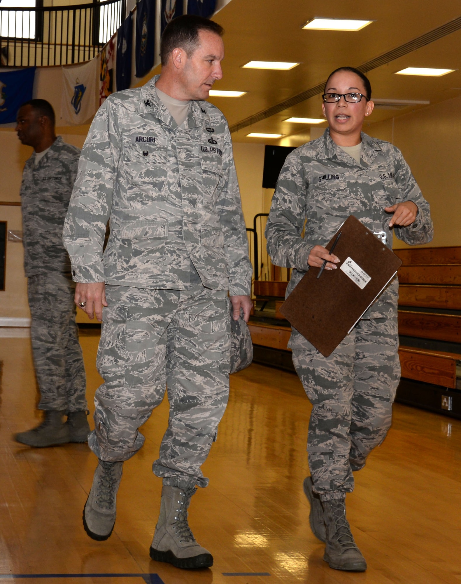 U.S. Air Force Col. Scott Arcuri, left, U.S. Air Forces in Europe - Air Forces Africa director of manpower, personnel, services, speaks with U.S. Air Force Staff Sgt. Lateasha Shilling, 100th Force Support Squadron NCO in charge of the fitness center, during his tour of the Hardstand Fitness Center Oct. 7, 2015, on RAF Mildenhall, England. Arcuri toured many areas of the facility including the weight rooms, indoor running track, basketball court and therapy rooms. (U.S. Air Force photo by Gina Randall/Released) 