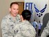 U.S. Air Force Col. Scott Arcuri, left, U.S. Air Forces in Europe - Air Forces Africa director of manpower, personnel, services, speaks with U.S. Air Force Staff Sgt. Lateasha Shilling, 100th Force Support Squadron NCO in charge of the fitness center, during his tour of the Hardstand Fitness Center Oct. 7, 2015, on RAF Mildenhall, England. Arcuri coined Shilling following her briefing of the facility. (U.S. Air Force photo by Gina Randall/Released) 